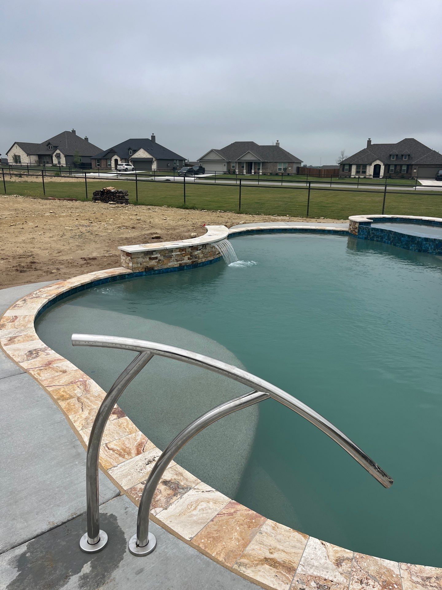 Freeform Pool with Raised Spa and Travertine Decking by Pinnacle Pools and Spas - DFW