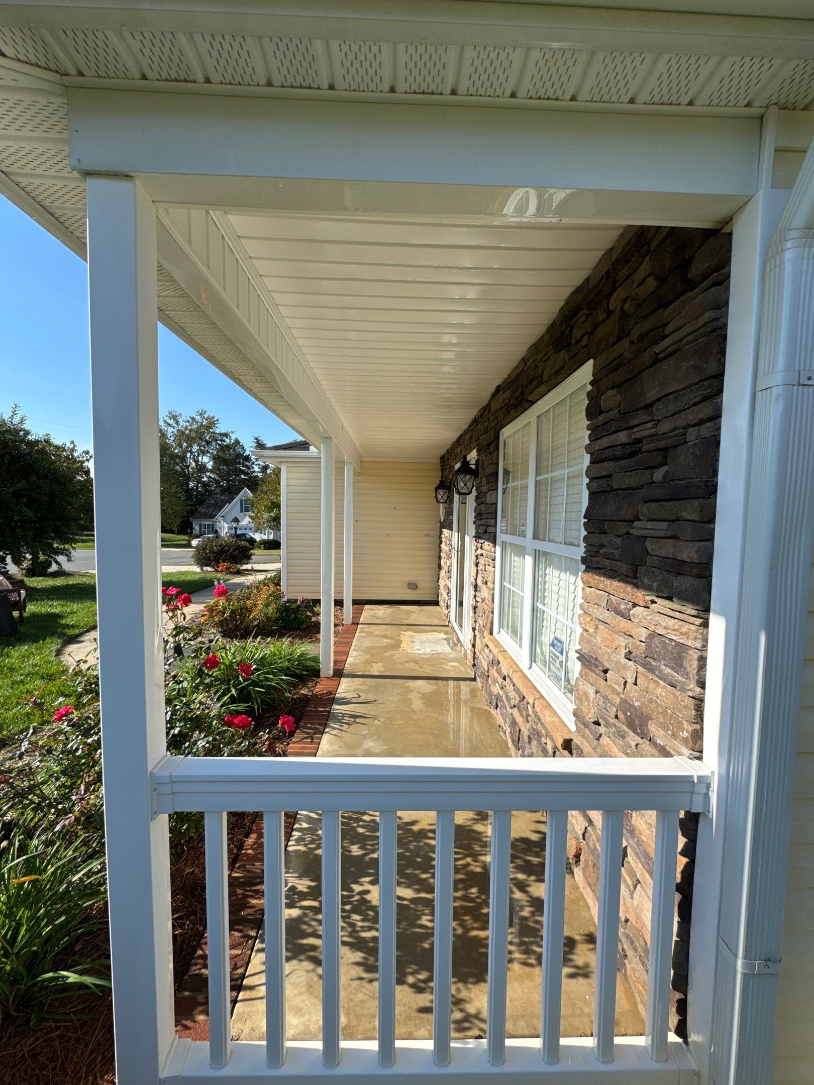 the service being done is cleaning the concrete walkway and the exterior of the house using pressure washing techniques