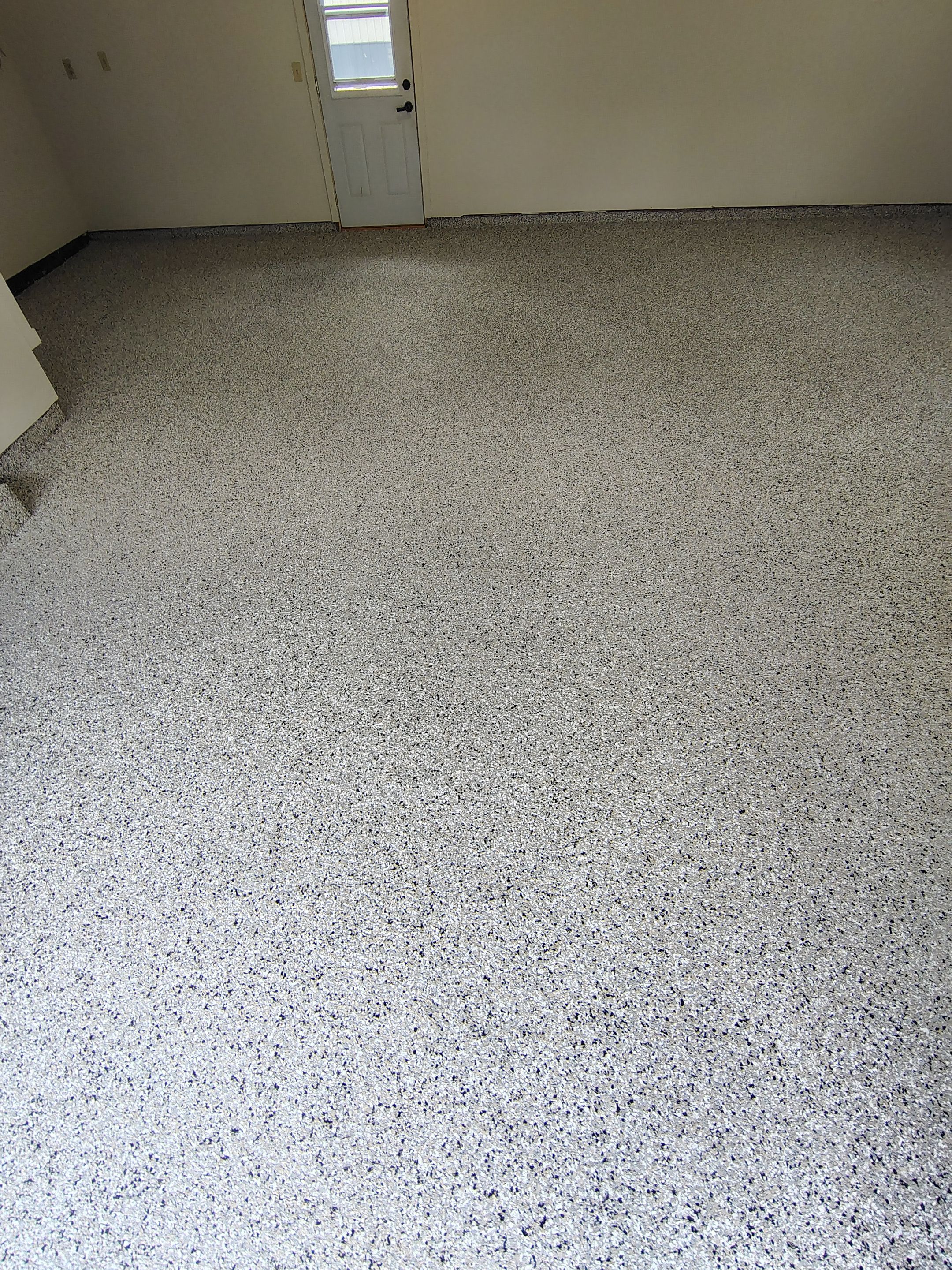 Full-Flake Epoxy Garage Floor Coating Installation in Sioux Falls by Select Painting, Coatings & Garage Cabinets