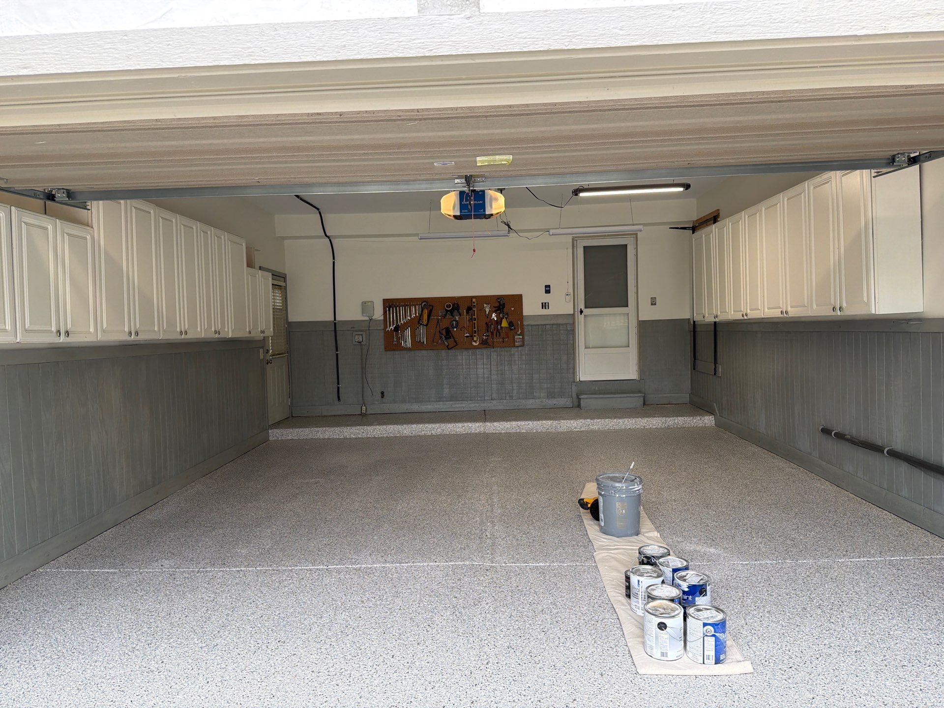Garage Renovation with Polyaspartic Flooring and Custom Painting in Troy by Top Shelf Painter