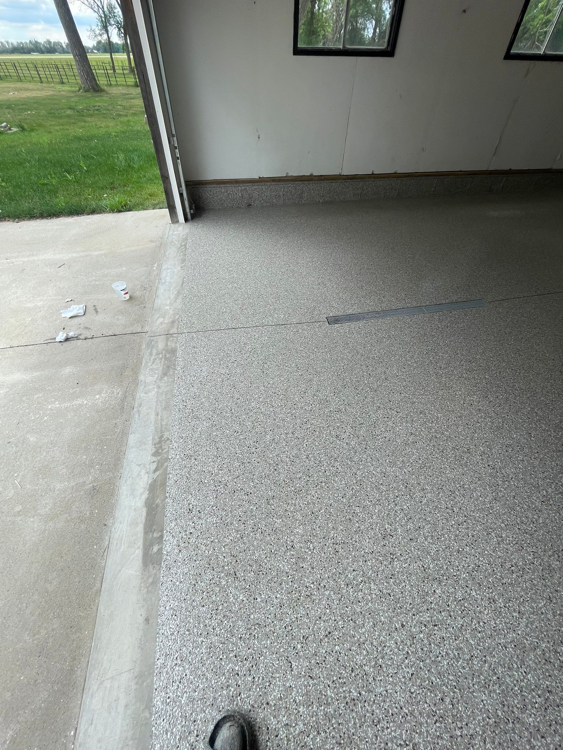 Hartford Residential Garage Floor Transformation With Decorative Chip Coating by Select Painting, Coatings & Garage Cabinets
