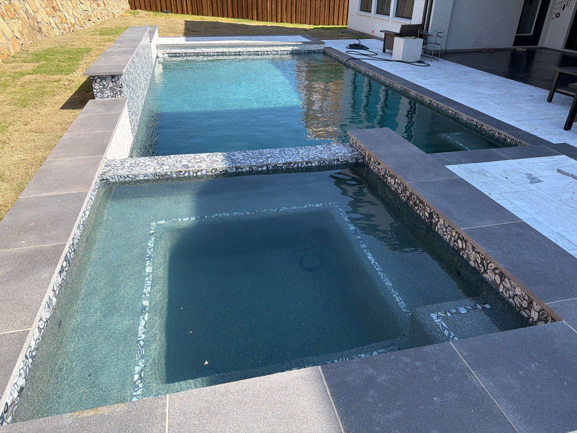 Modern Geometric Pool with Raised Spa and Marble Deck by Pinnacle Pools and Spas - DFW