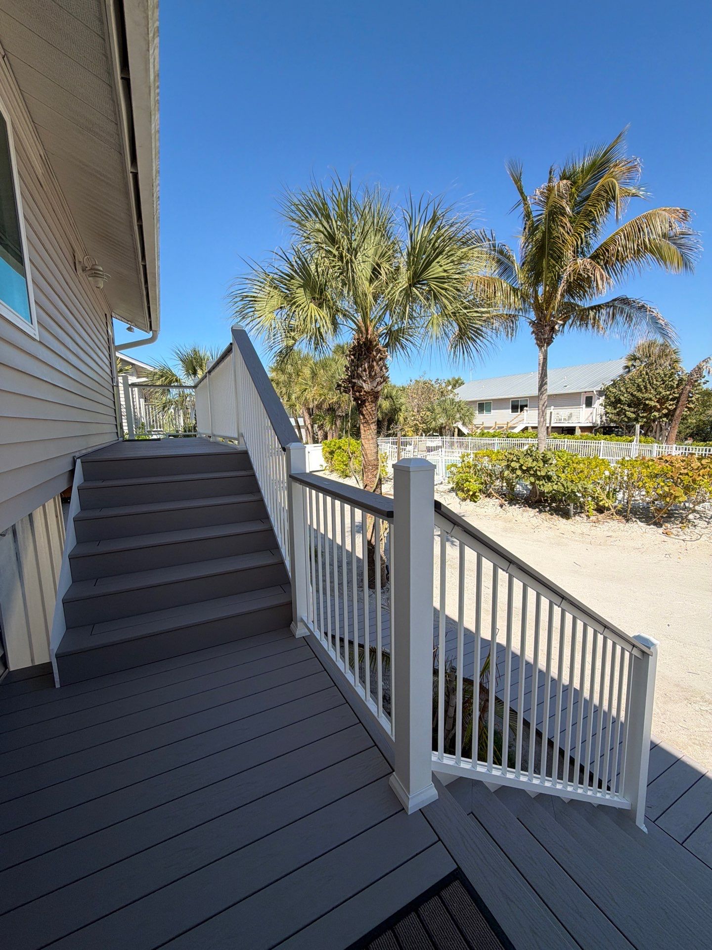 Elevated Coastal Home Renovation with Siding and Custom Decks in Englewood by Smirnov Construction Inc