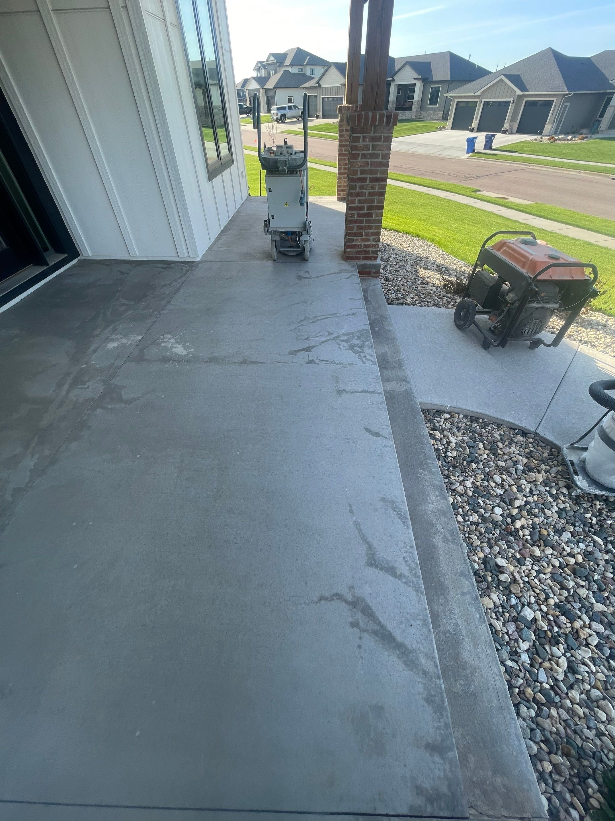 Grey Speckled Concrete Porch Coating for Sioux Falls Home by Select Painting, Coatings & Garage Cabinets