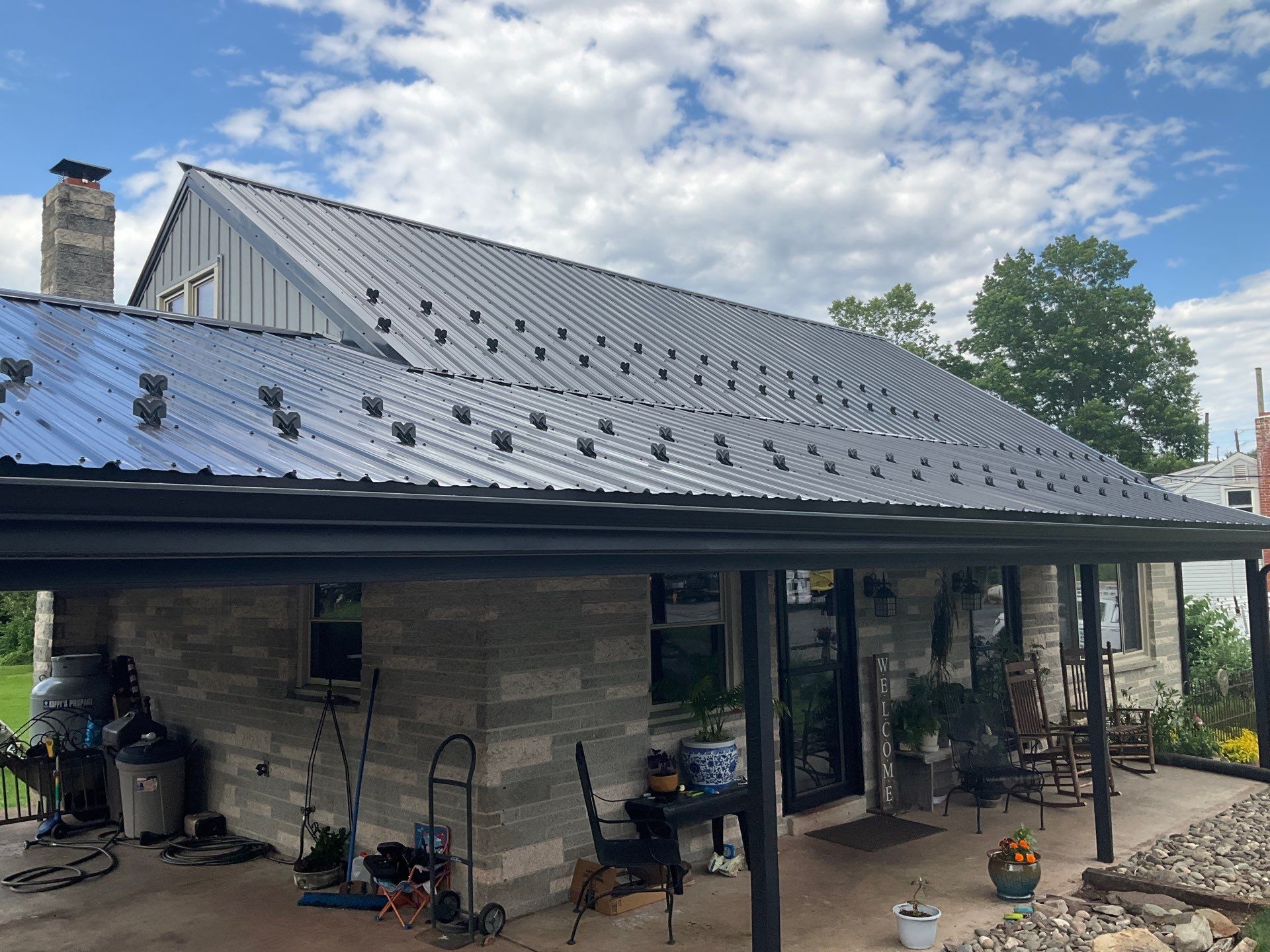 Metal Roofing, Board & Batten Siding, and Entry Door Transformation by Esh Builders