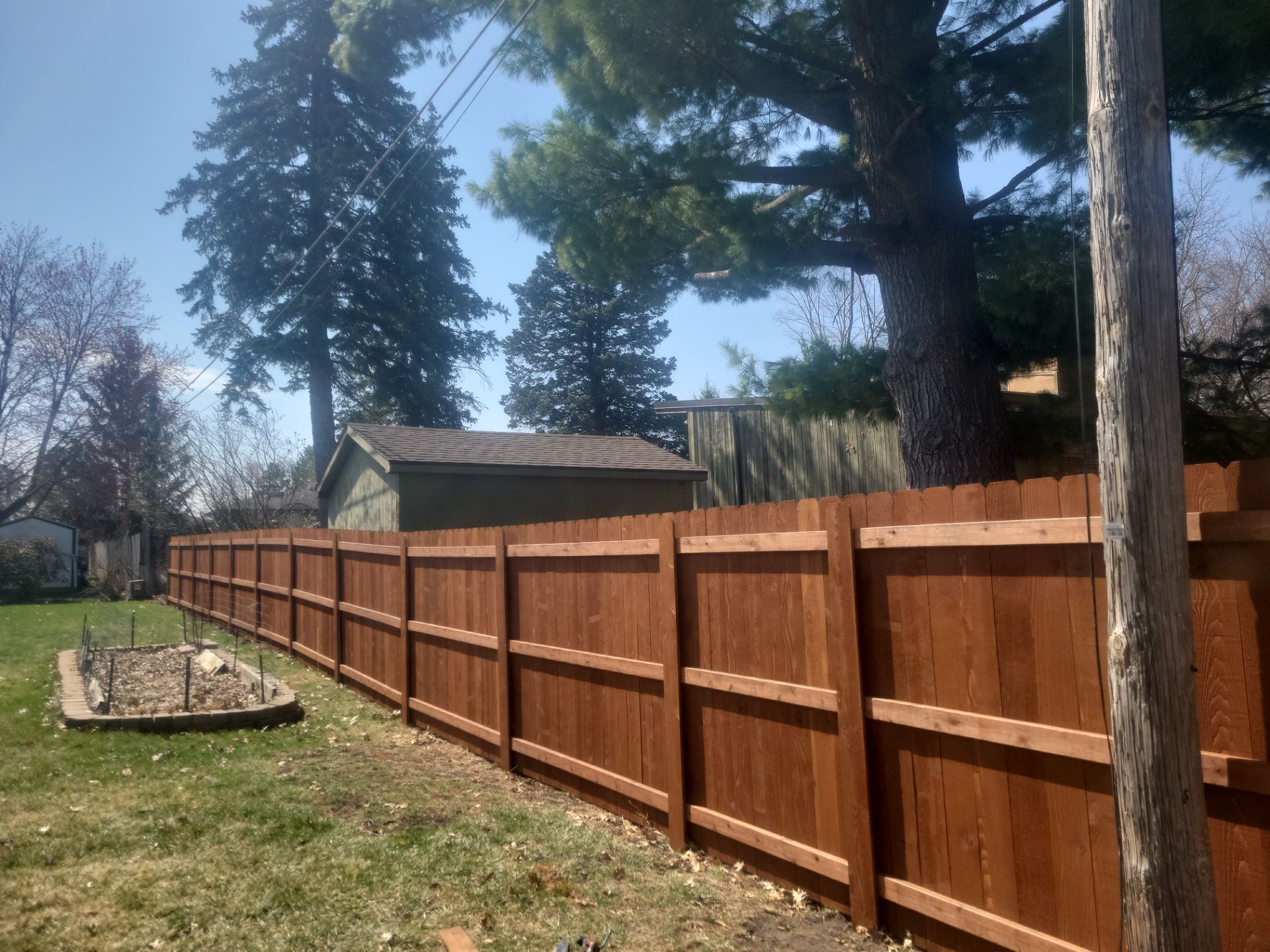 Stained Cedar Wood Privacy Fence Installation in Cedar Falls by Perfect Picket Fence and Stain