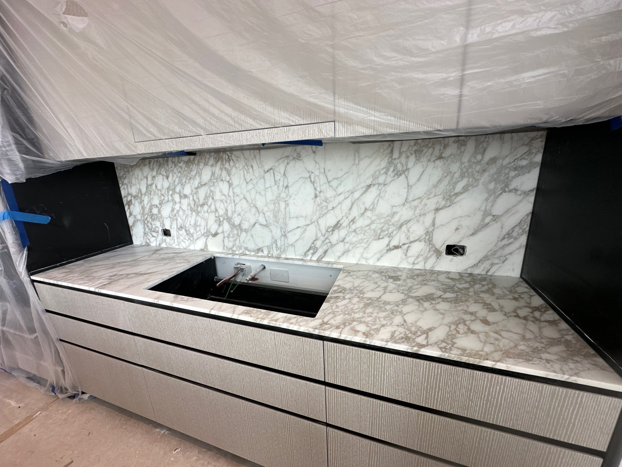 Kitchen Countertop with backsplash and Island top with mitered waterfalls by NC Stone And Tiles