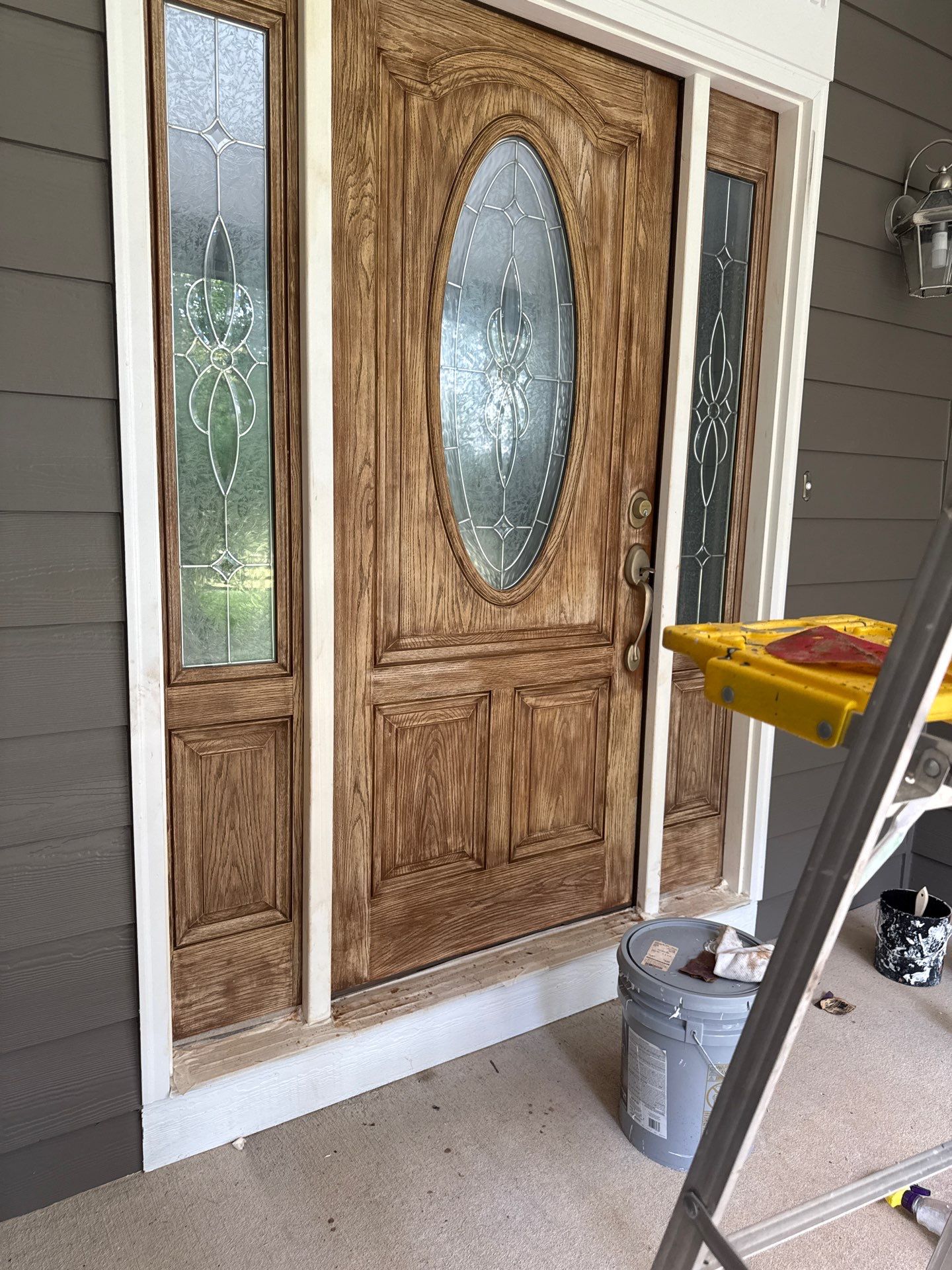 Siding replacement, exterior painting, and front door staining. by GonzalezPainters & Contractors Inc
