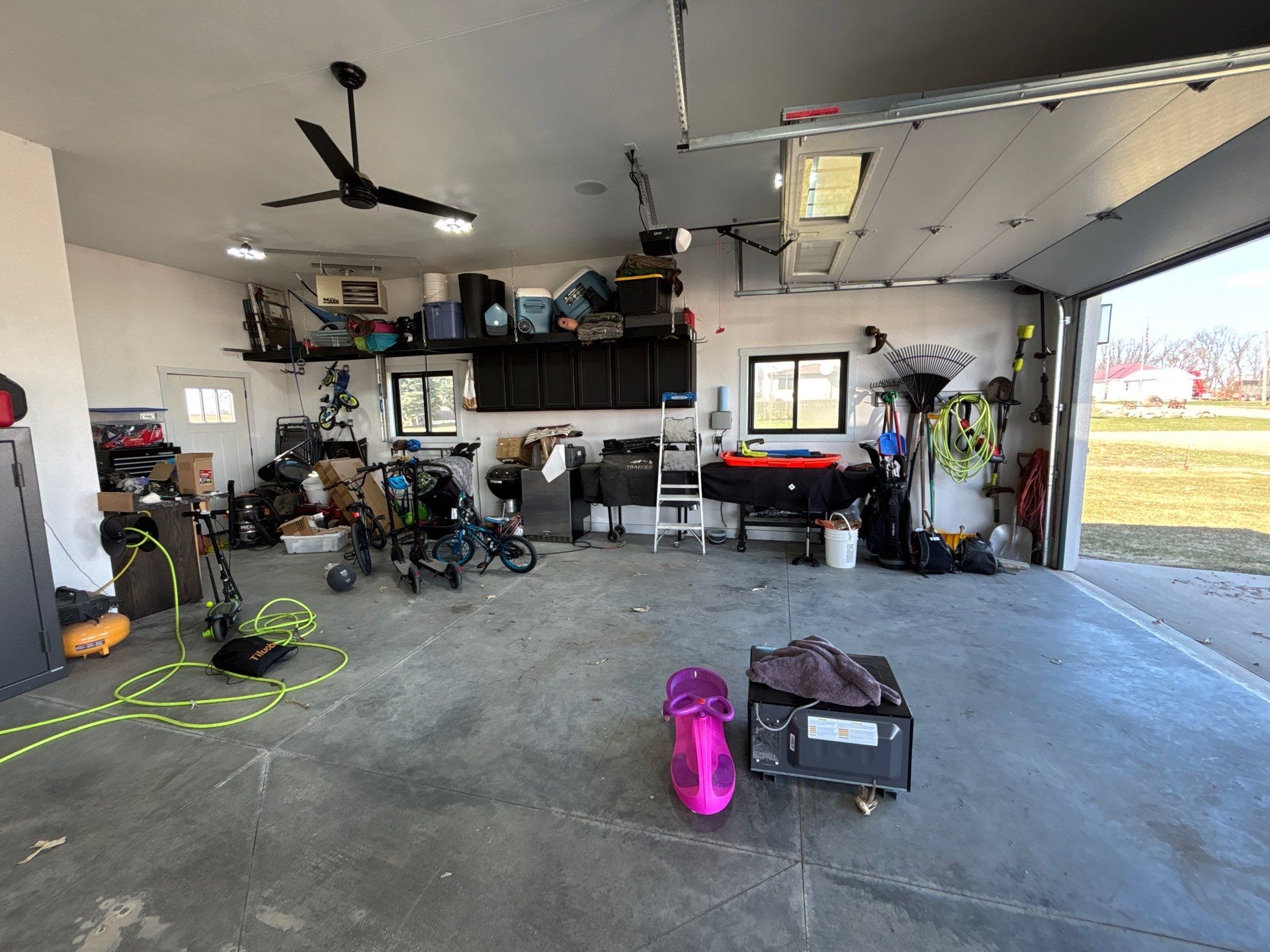 Speckled Polyaspartic Garage Floor Coating Installation in Dell Rapids by Select Painting, Coatings & Garage Cabinets