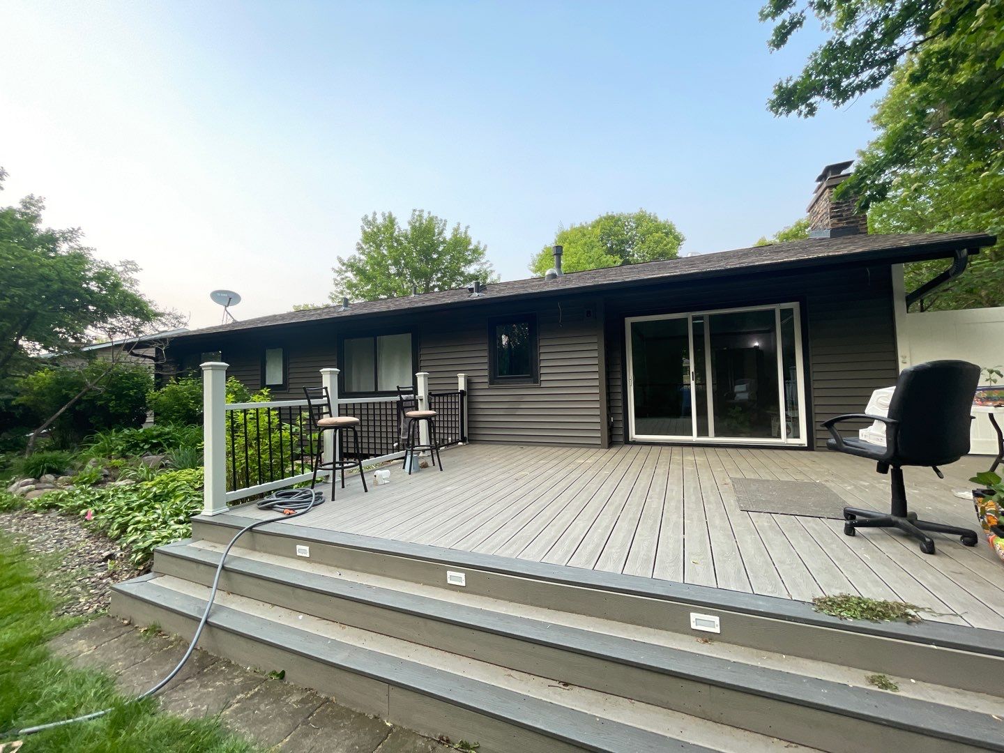 Premium Exterior Remodel – Alside Charter Oak Siding, Hayfield Black Frame Windows, Edco Soffit & Fascia by First Impressions Exteriors