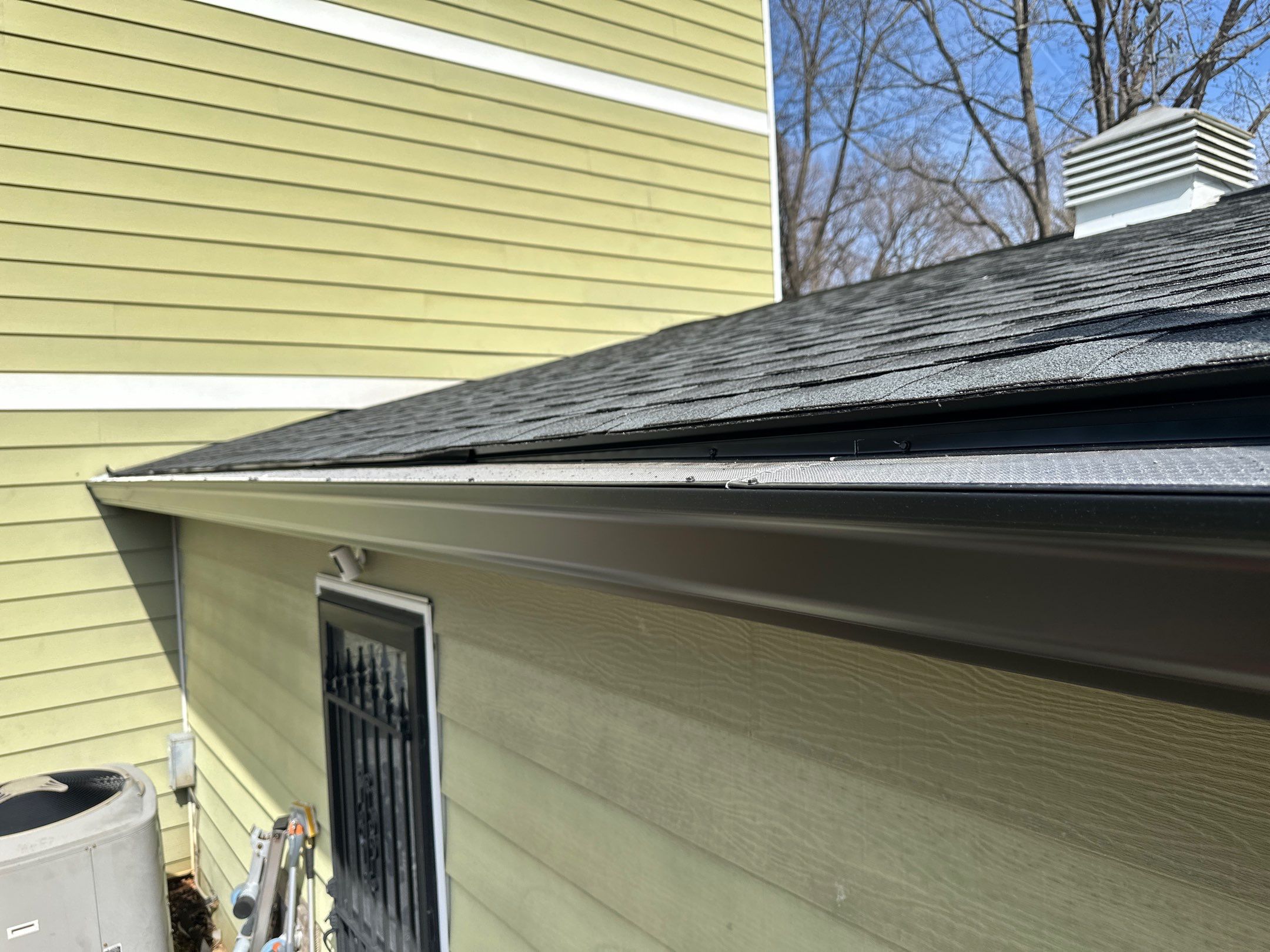 Blacked Out Gutters / Gutter Guards by American Home Contractors