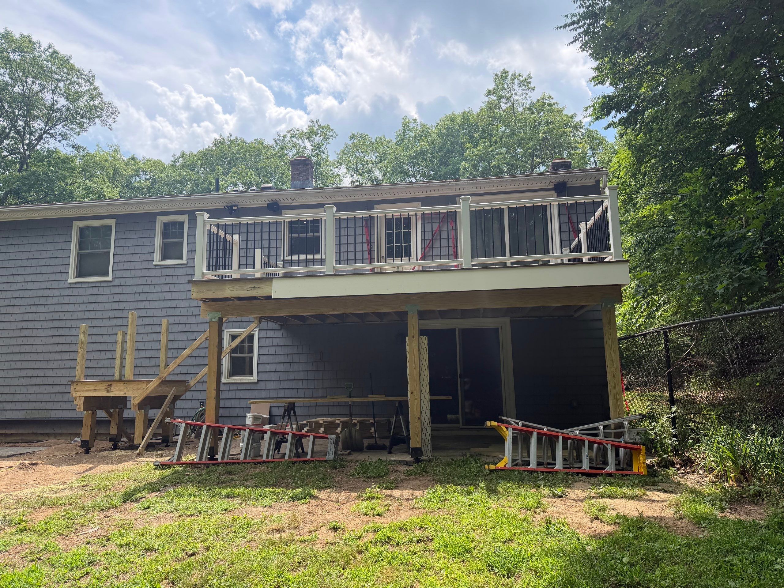 Deck replacement using trex tropical Havana Gold and transcend white railings by DiGiorgi Roofing and Siding Inc