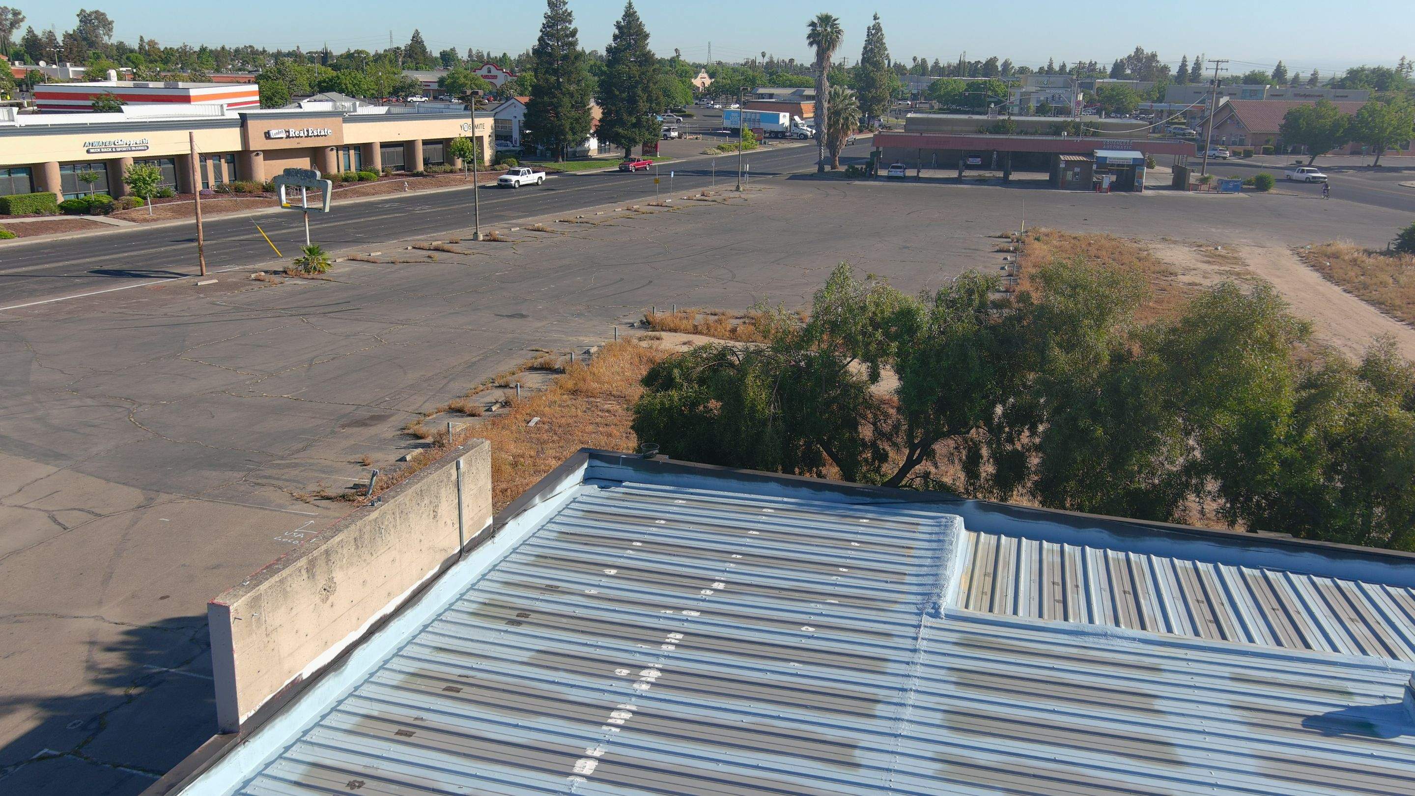 Metal roof restoration on commercial roof using Conklin Benchmark/ PUMA XL acrylic coatings over metal and foam by Straight Edge Roofing Inc