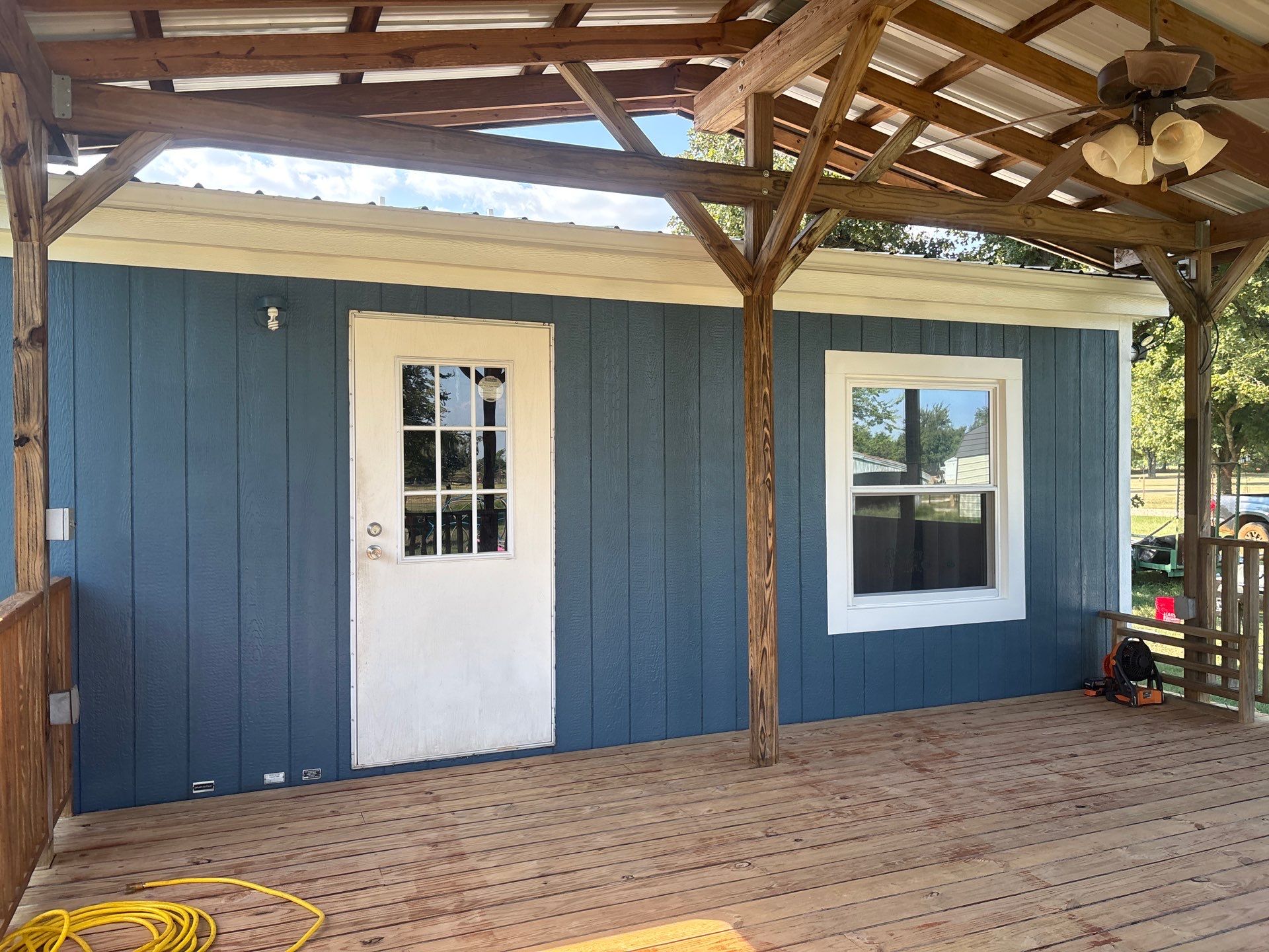 Exterior Painting in Fruitvale, TX | Wood Porch & Home in Deep Navy Blue by Quality Coats Painting