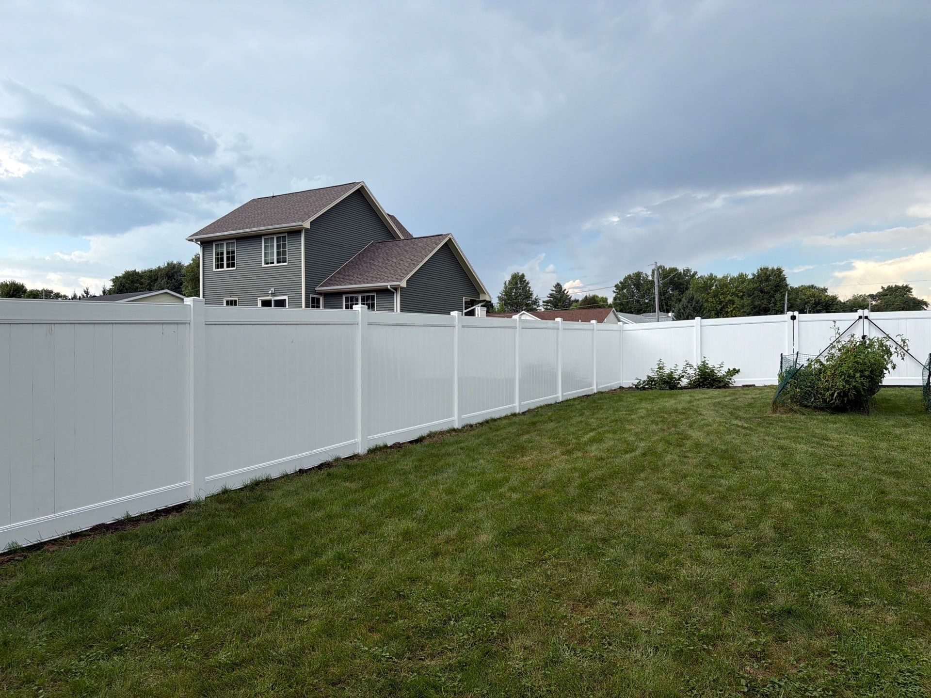 White Vinyl Privacy Fence Installation in Raymond, IA by Perfect Picket Fence and Stain