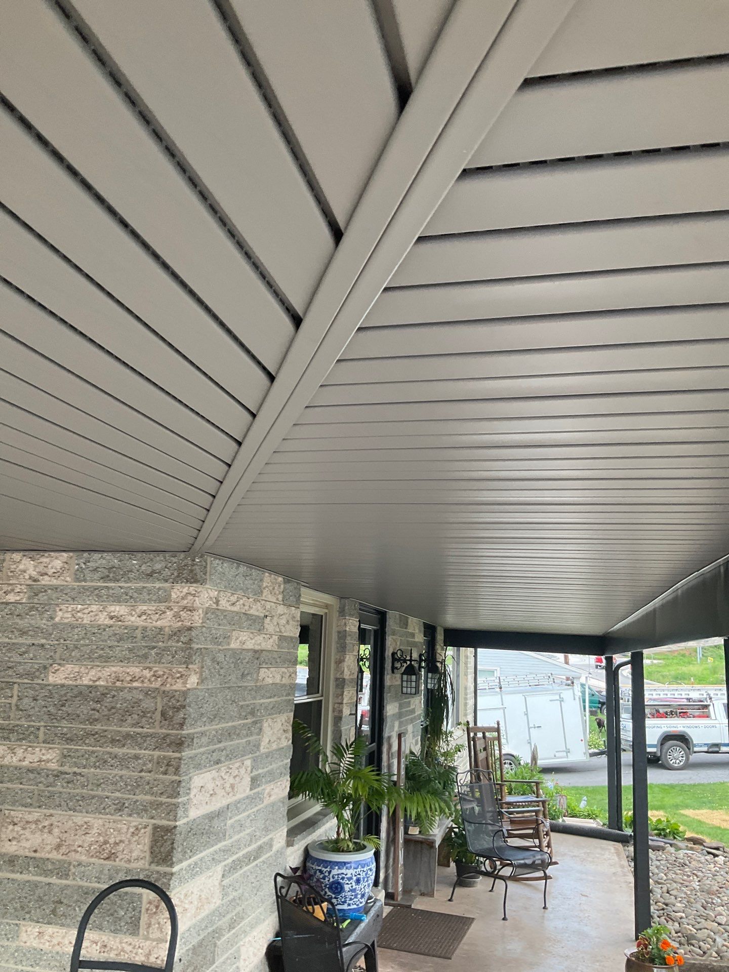 Metal Roofing, Board & Batten Siding, and Entry Door Transformation by Esh Builders