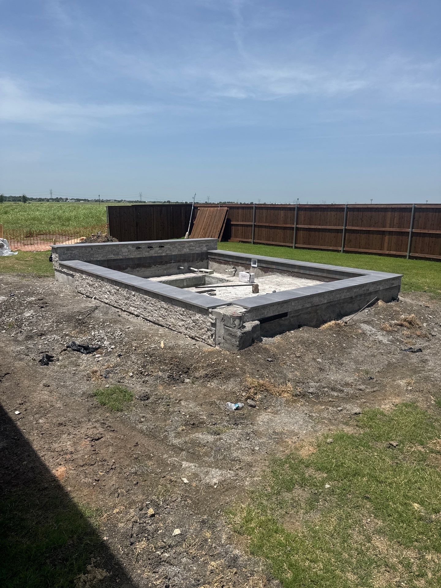 Modern Spool with Tanning Ledge and In-Water Loungers by Pinnacle Pools and Spas - DFW