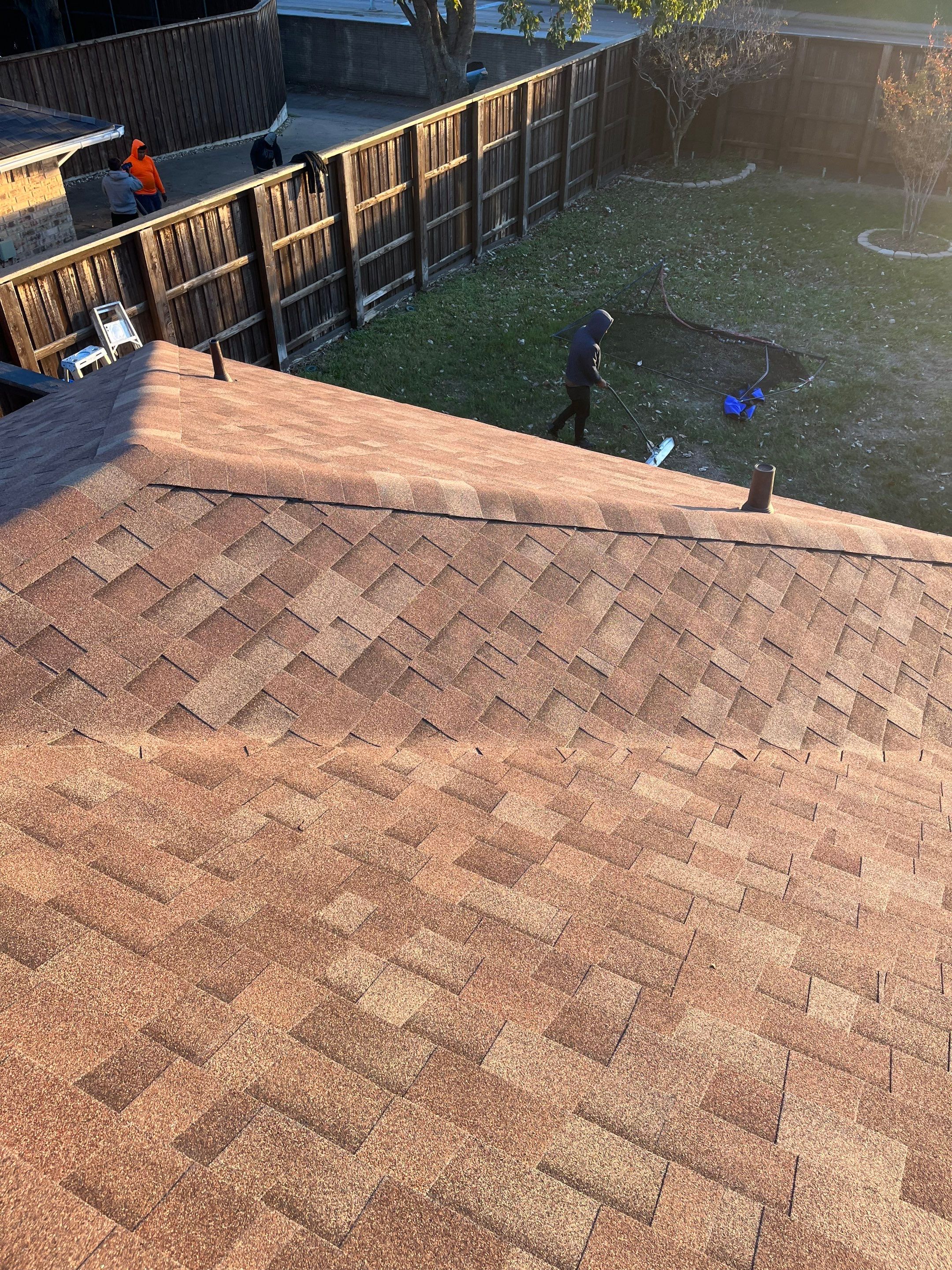 Brick with white area around windows with Malarkey Sienna Blend by Tejas Roofworks + Restoration