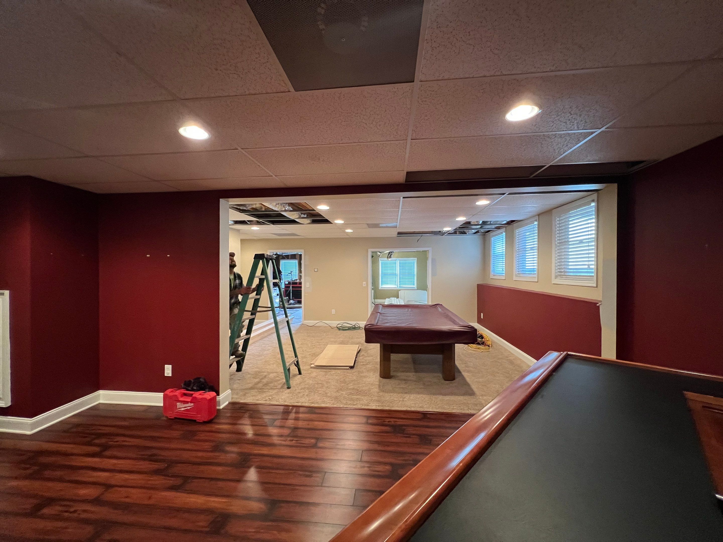 Modern Basement Remodeling in Woodstock with Custom Live-Edge Bar by Swift Home Renovations