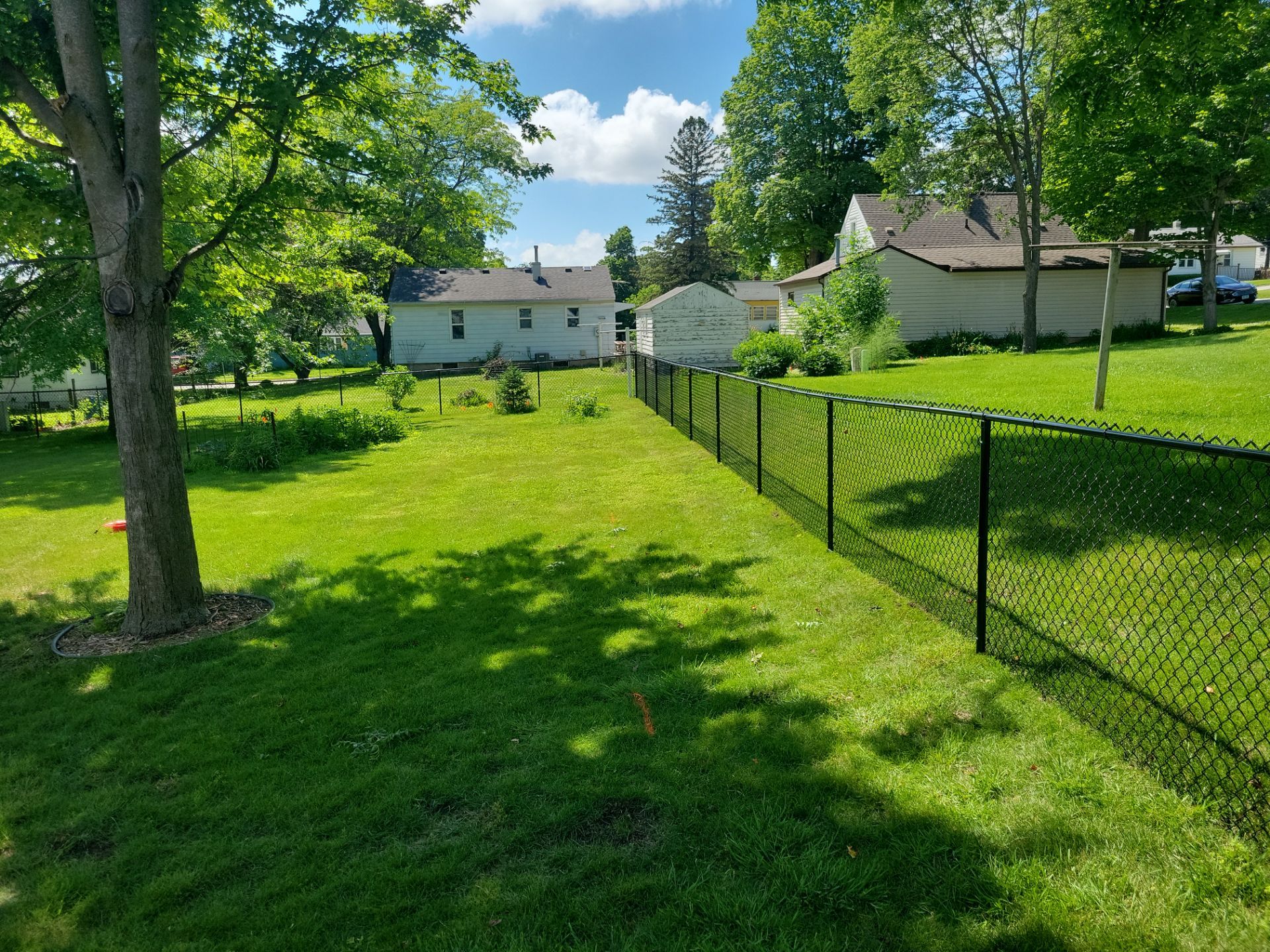 Black Chain Link Perimeter Fence and Driveway Gate in Waverly by Perfect Picket Fence and Stain