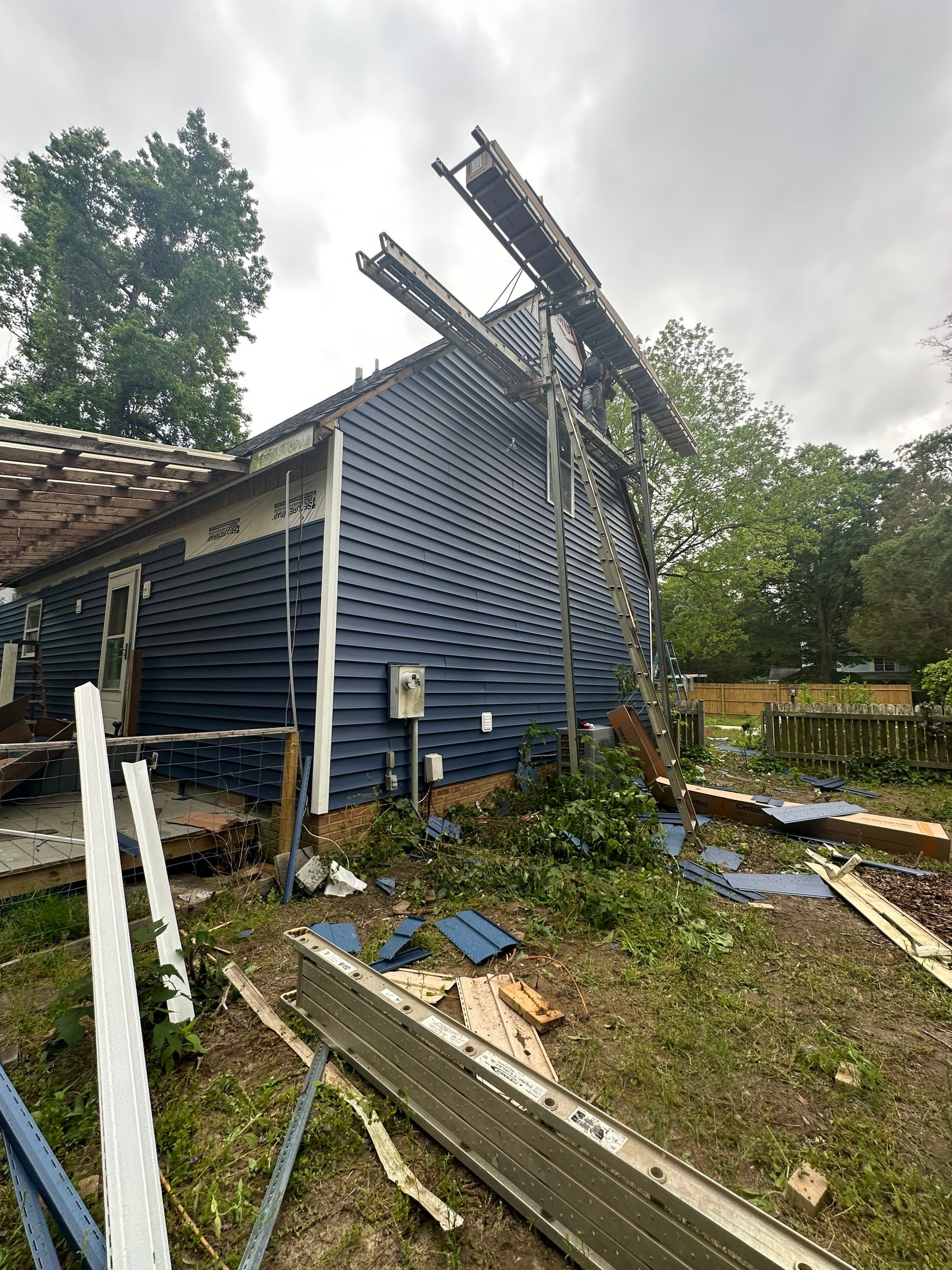 Gloucester Exterior Overhaul with Navy Blue Siding and New Roof by Cade Construction