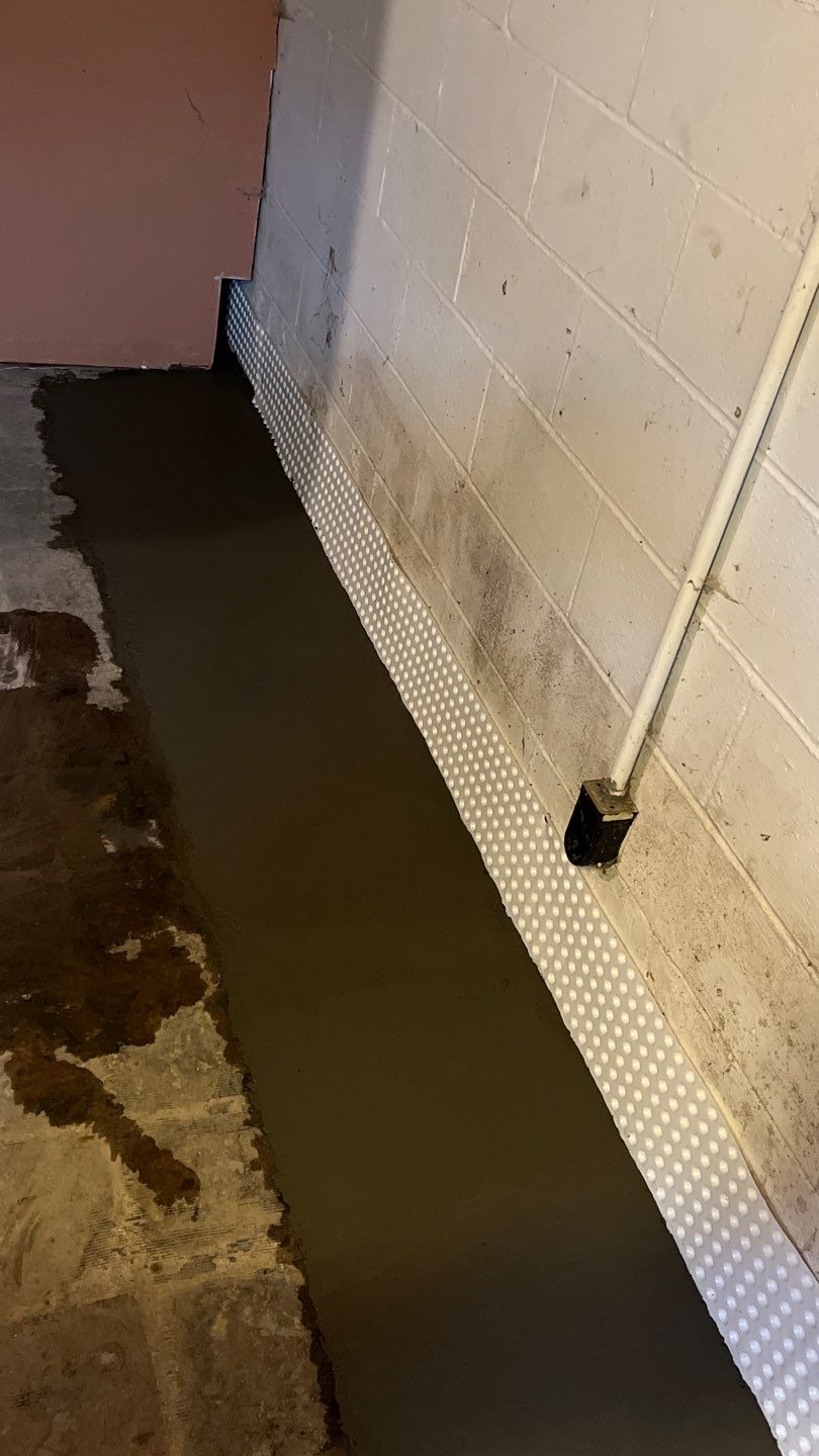 Interior drain tile system installation by ACE Waterproofing & Basement Solutions