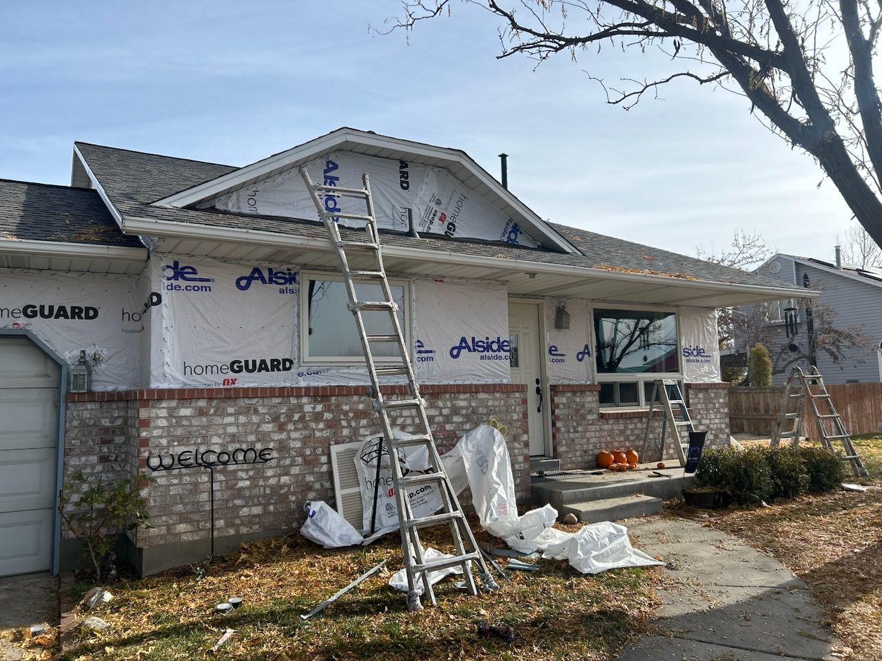 Aluminum Siding Replacement with Blue Dutch Lap Vinyl Siding and White Trim by ASAP Roofing & Exteriors
