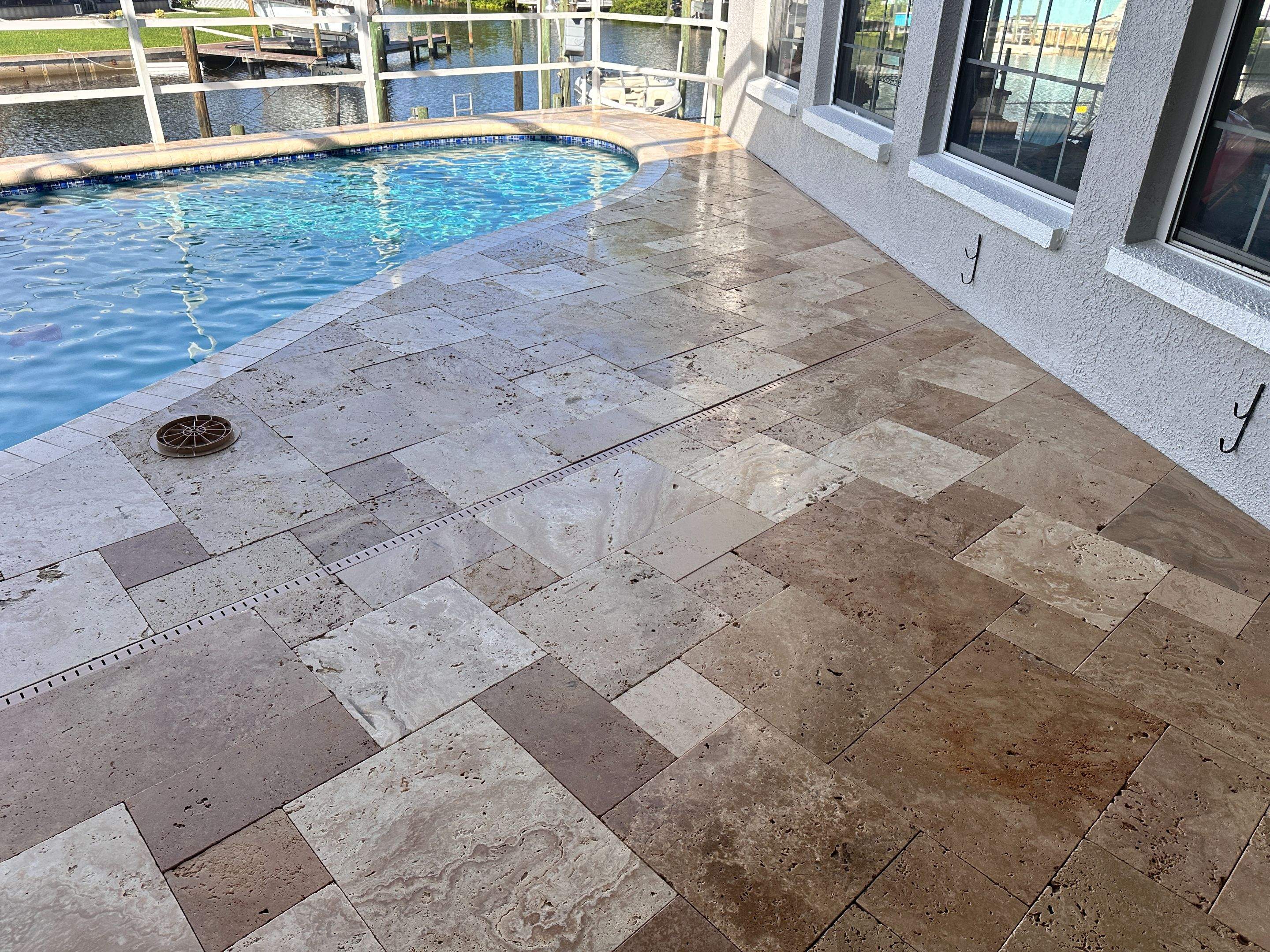 Travertine Sealing and Stripping for a Waterfront Pool Deck in Apollo Beach by Supreme Paver Experts