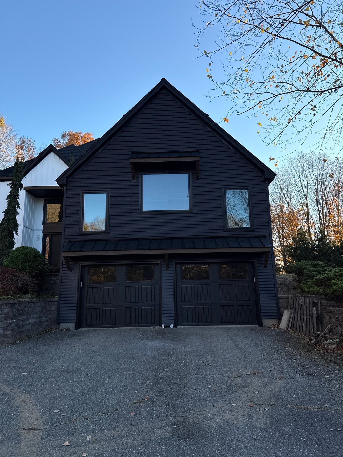 Bold Siding transformation with Cert Cedar Board & Batten S12, White, and Cert Monogram D/4 x 12'6" clapboard, Tuxedo by DiGiorgi Roofing and Siding Inc