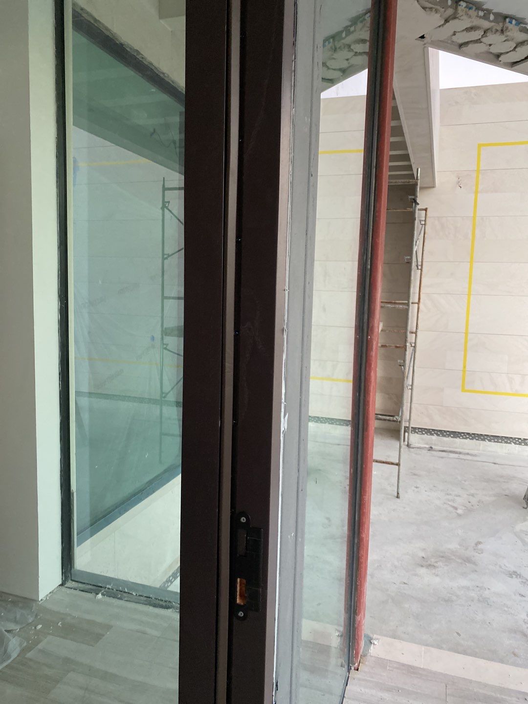 Custom Material Pivot Door installation by Impact Precious Wood Inc.