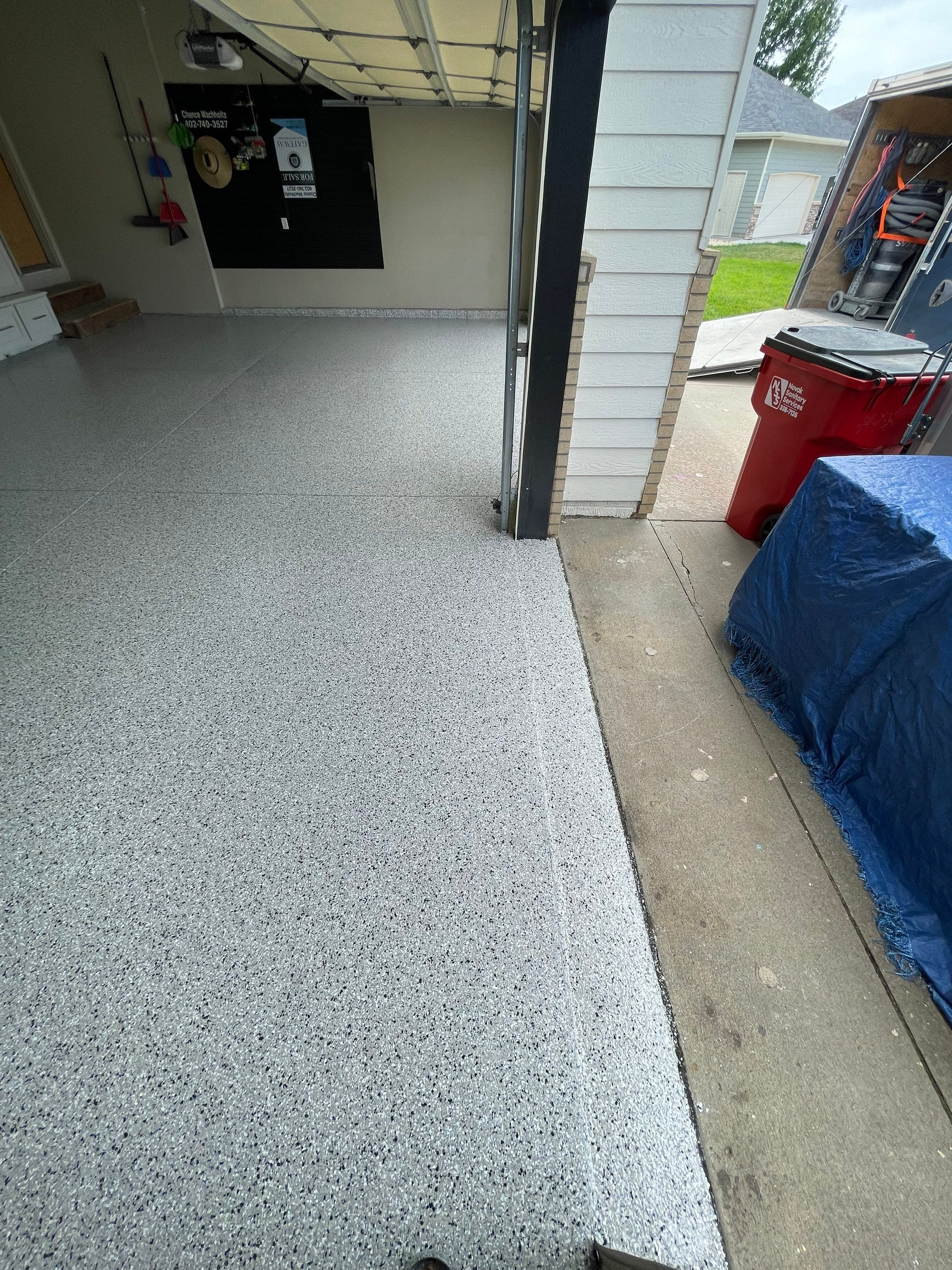 Cabin FEver Flake Garage Floor Coating Installation in Sioux Falls by Select Painting, Coatings & Garage Cabinets