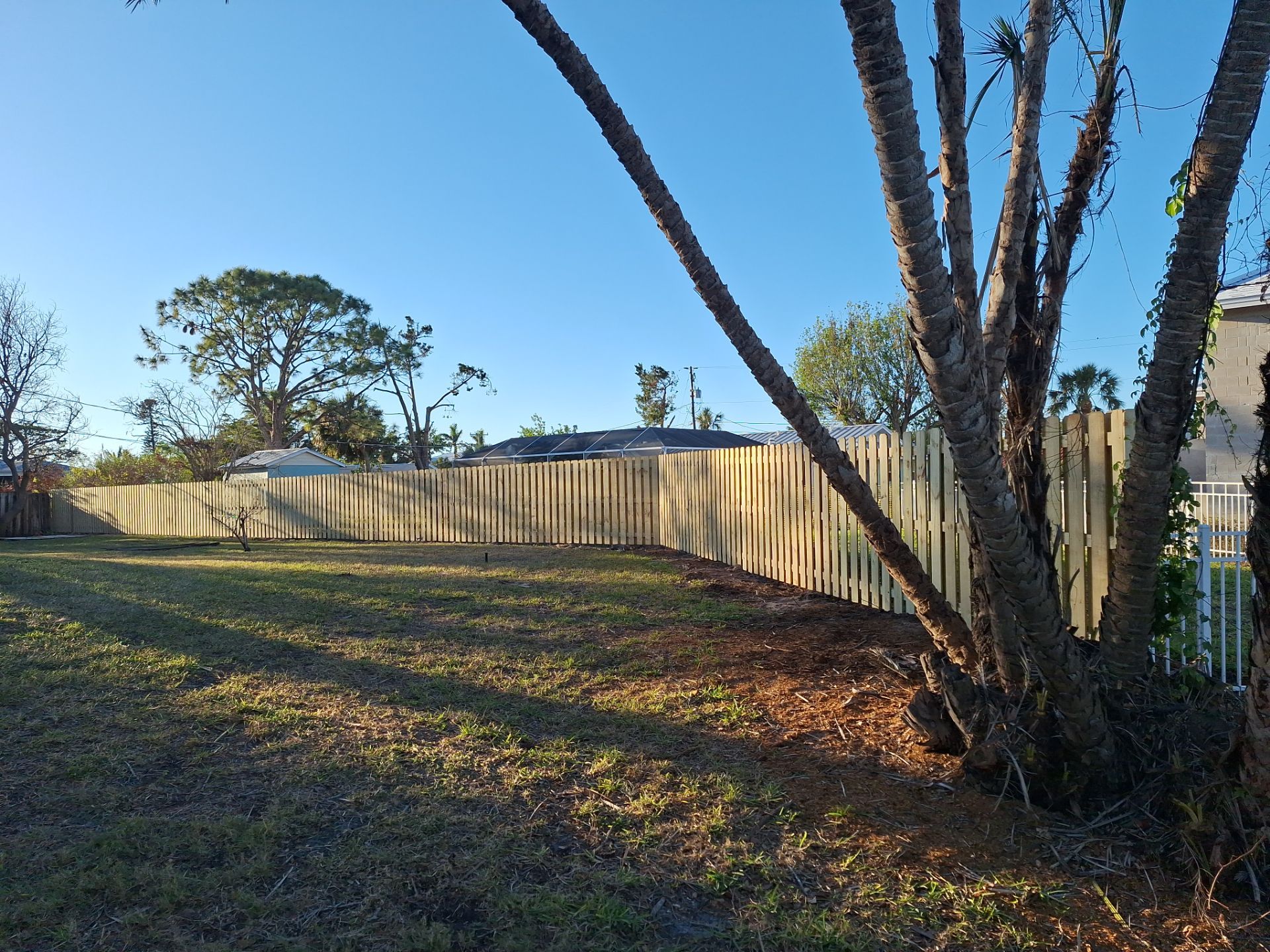Wood Fence Installation using 6ft Pressure-Treated Wood Board-On-Board Privacy Fence with a 4Ft 3 Rail White Aluminum Fence by Asap fence and gates, LLC