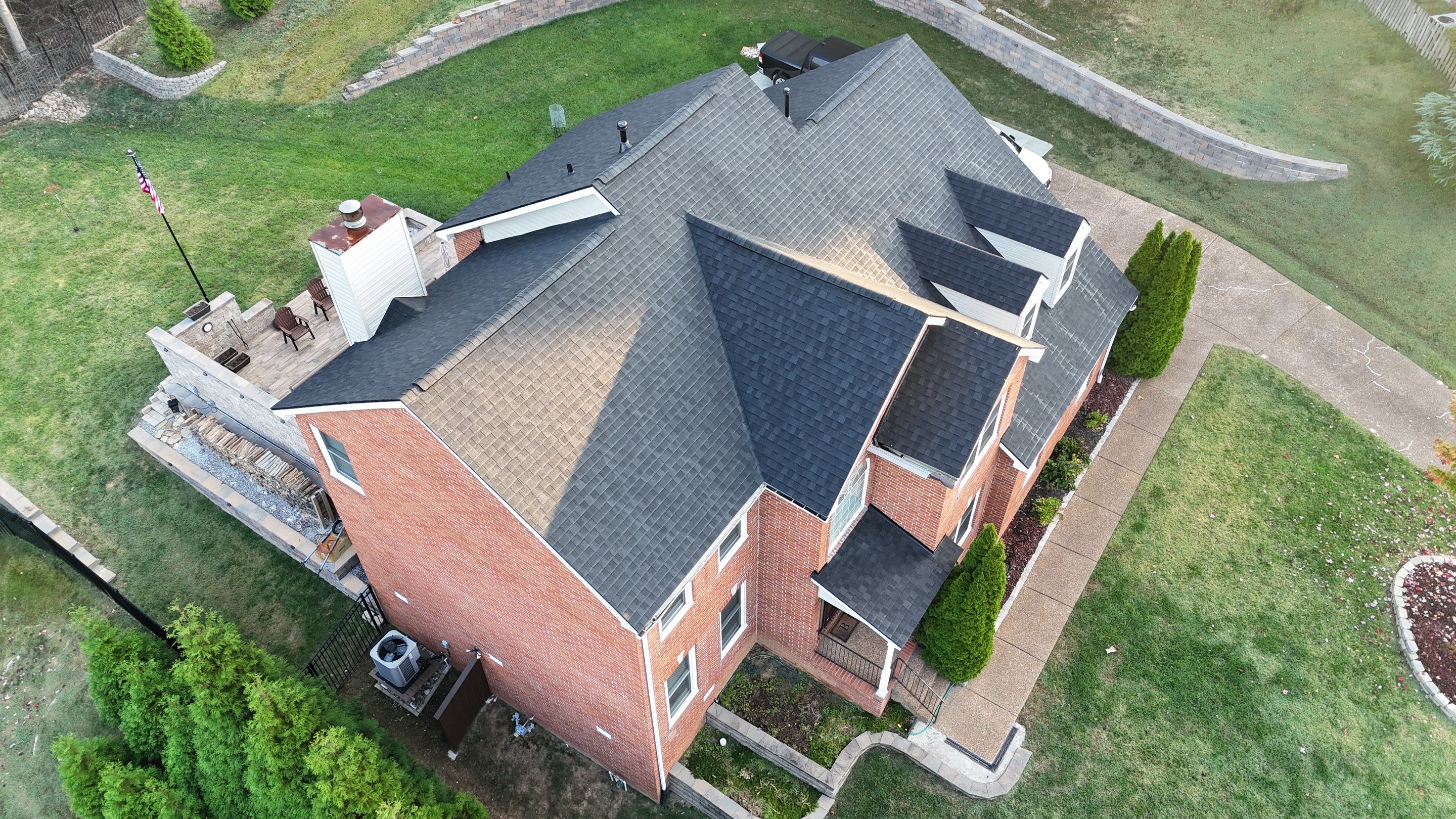 Charcoal Black Re-Roof & Gutters by Royal House LLC