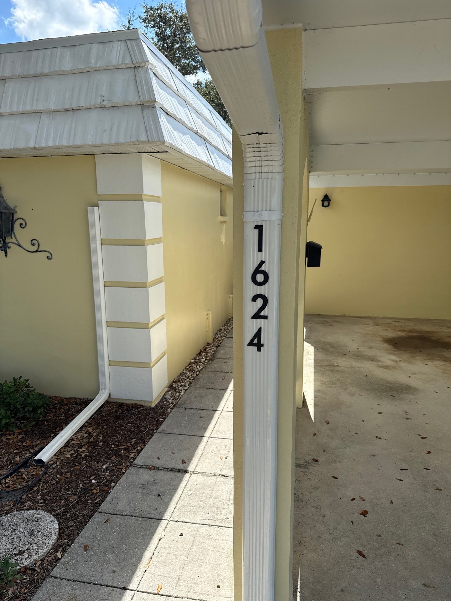 White Gutters and Matching Downspouts in Sarasota FL by Gutter Professors