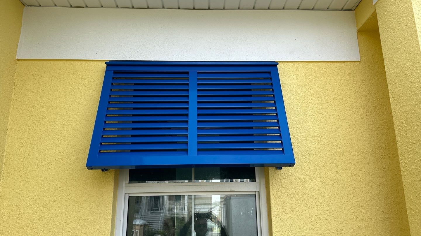 Bahama Shutters in Traffic Blue by Smart Guard Shutters