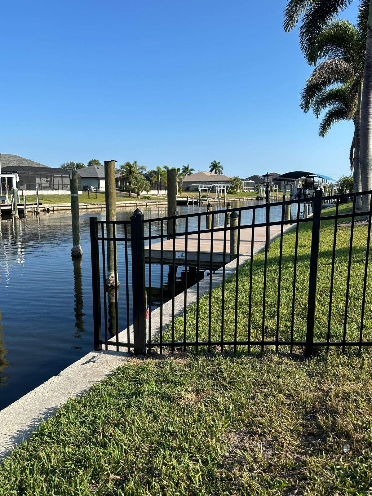 Waterfront Black Aluminum Fence Installation in Port Charlotte by True Fence LLC