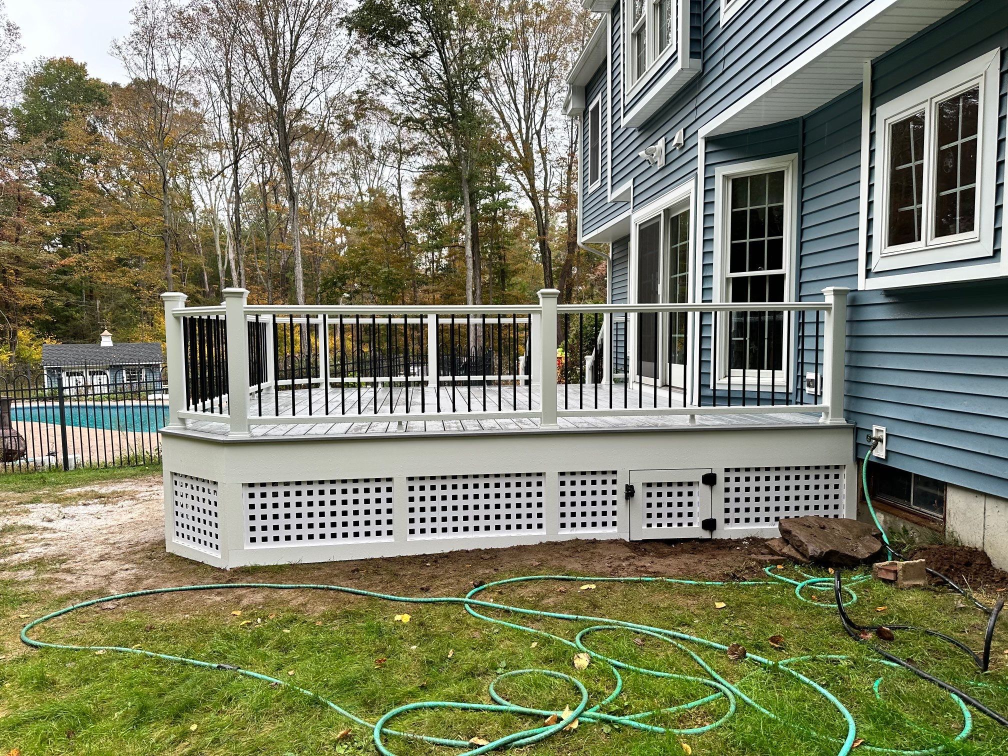 Deck replacement using Trex lineage Rainier with angled edges, Transcend cocktail rail and lattice. by DiGiorgi Roofing and Siding Inc