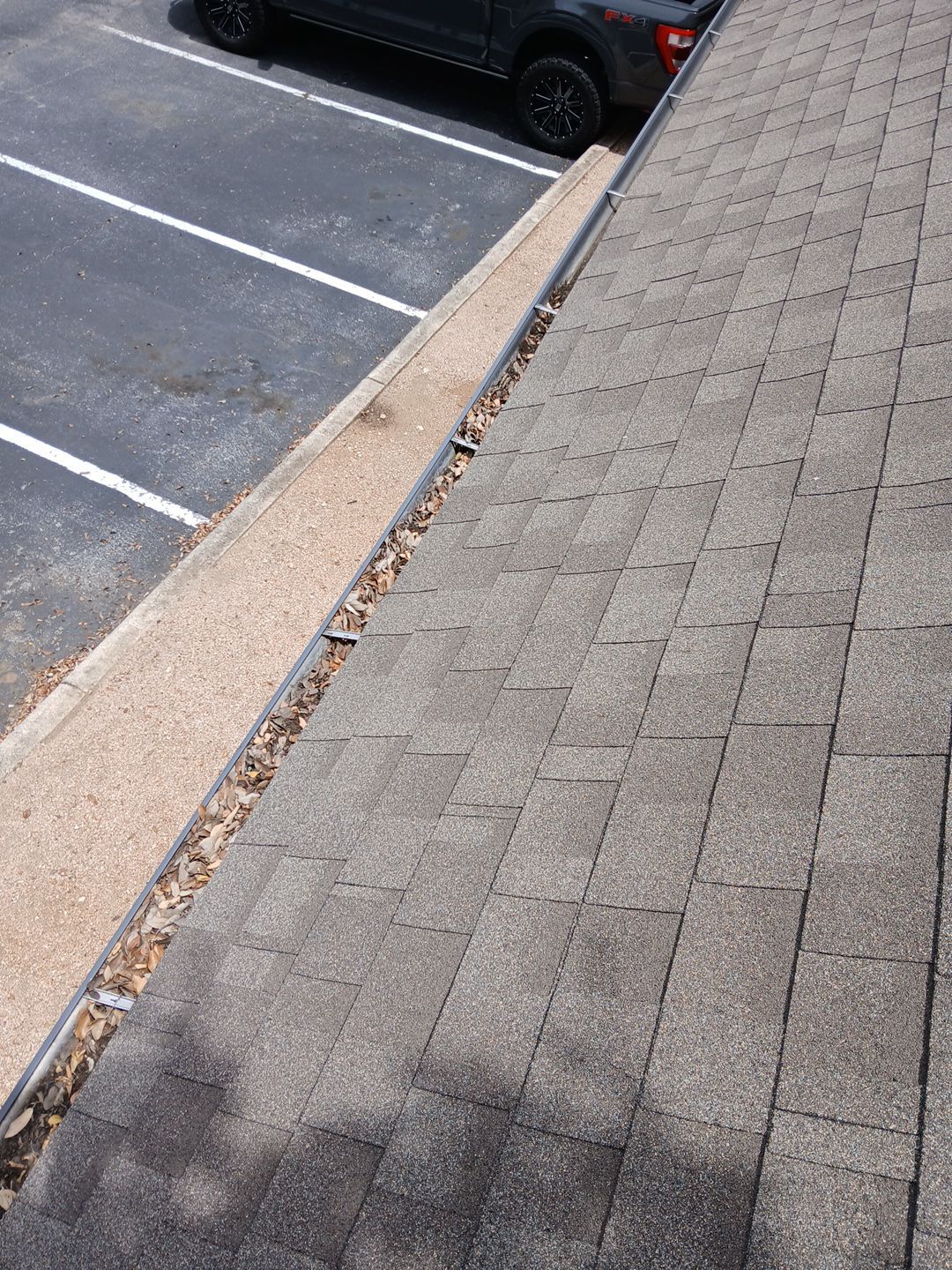 Commercial gutter cleaning San Antonio before photo with filled gutters