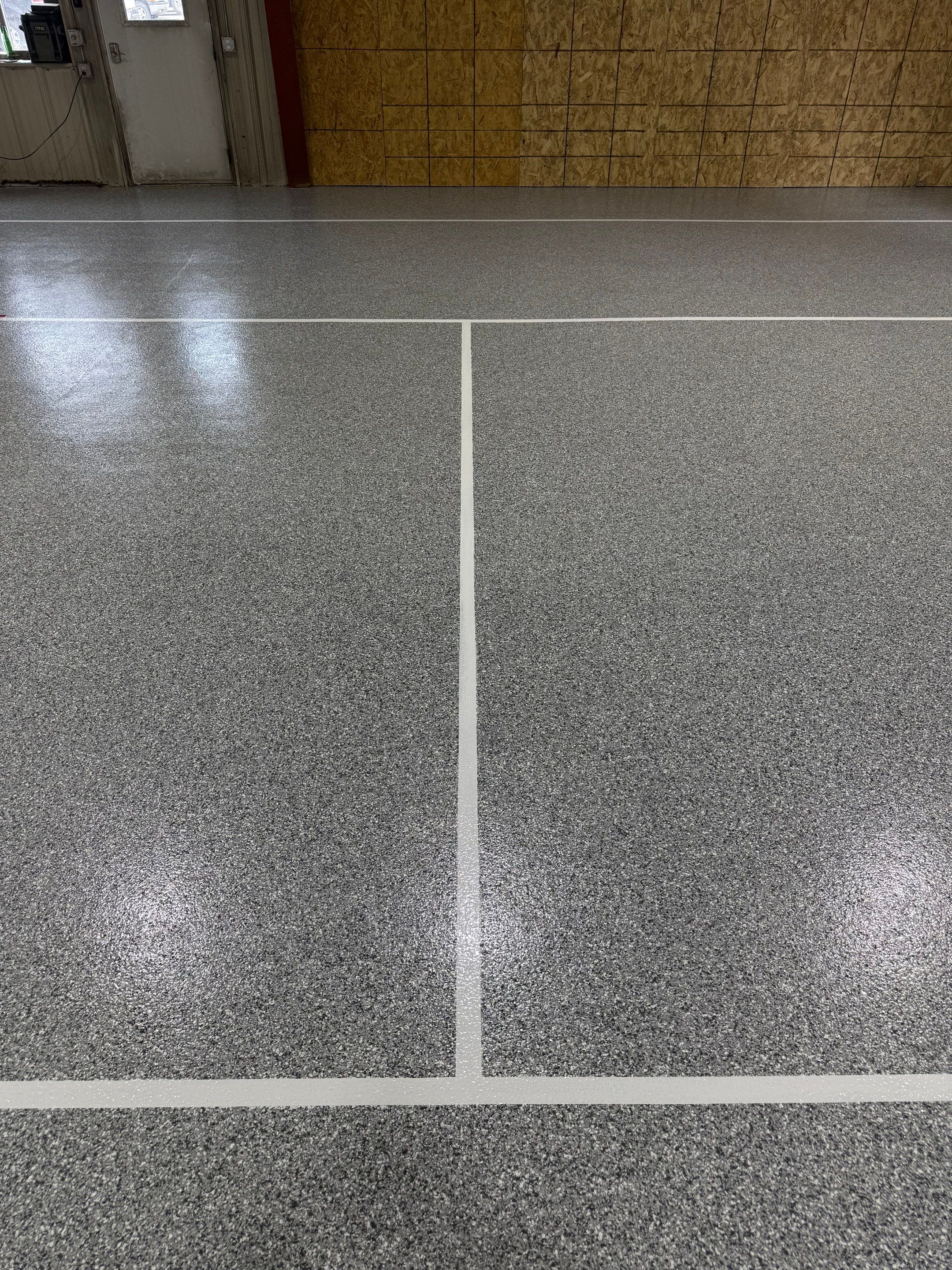 Custom Polyurea Shop Floor with Basketball Court Lines in Rock Valley by Select Painting, Coatings & Garage Cabinets