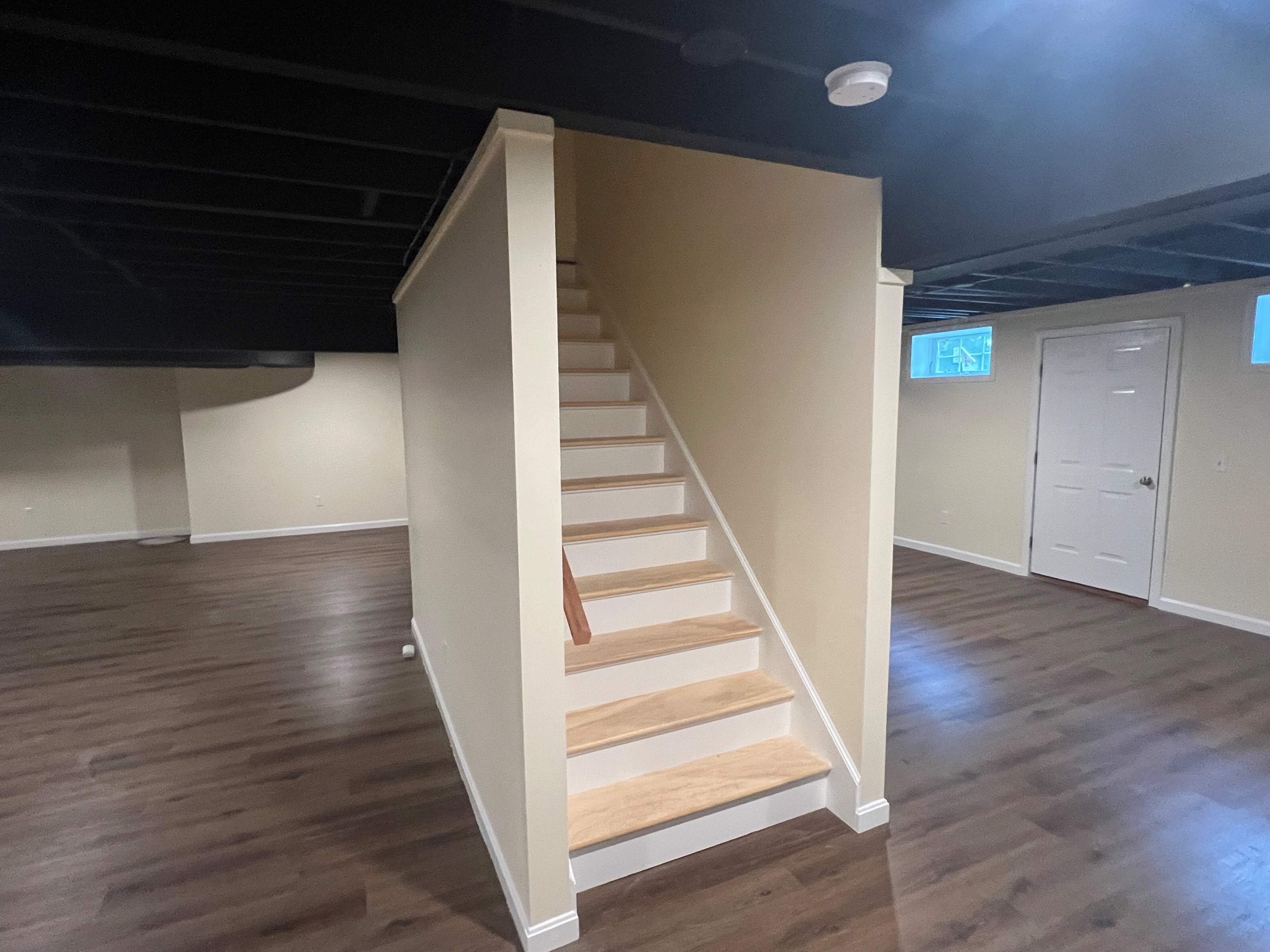 Basement Remodel w/ LVP Flooring & Exposed Ceiling by Chagnon Building & Remodeling LLC