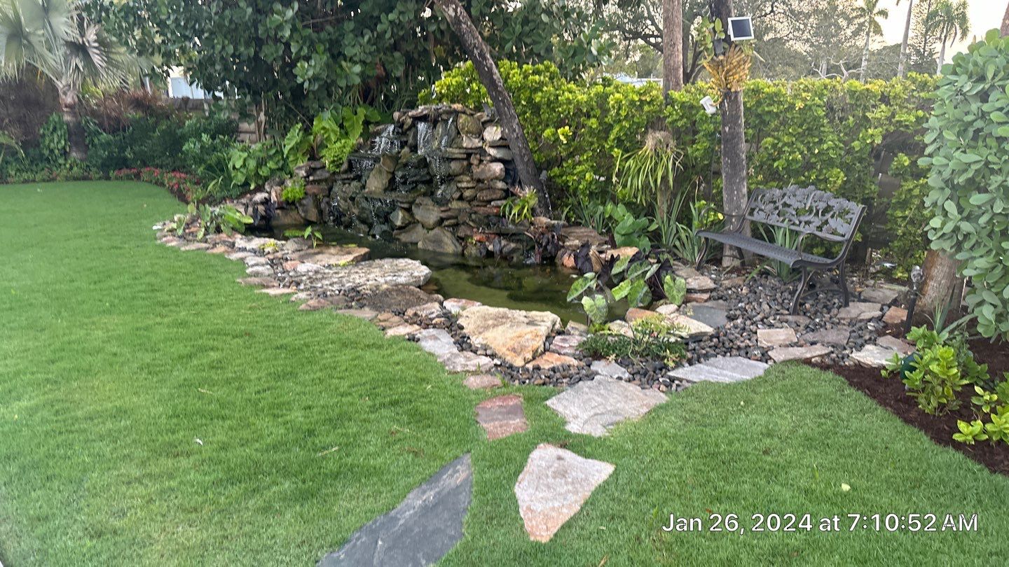 A Beautiful Relaxing Koi Pond with Waterfall in Pinecrest by Nature's Dream Landscape and Tree Service
