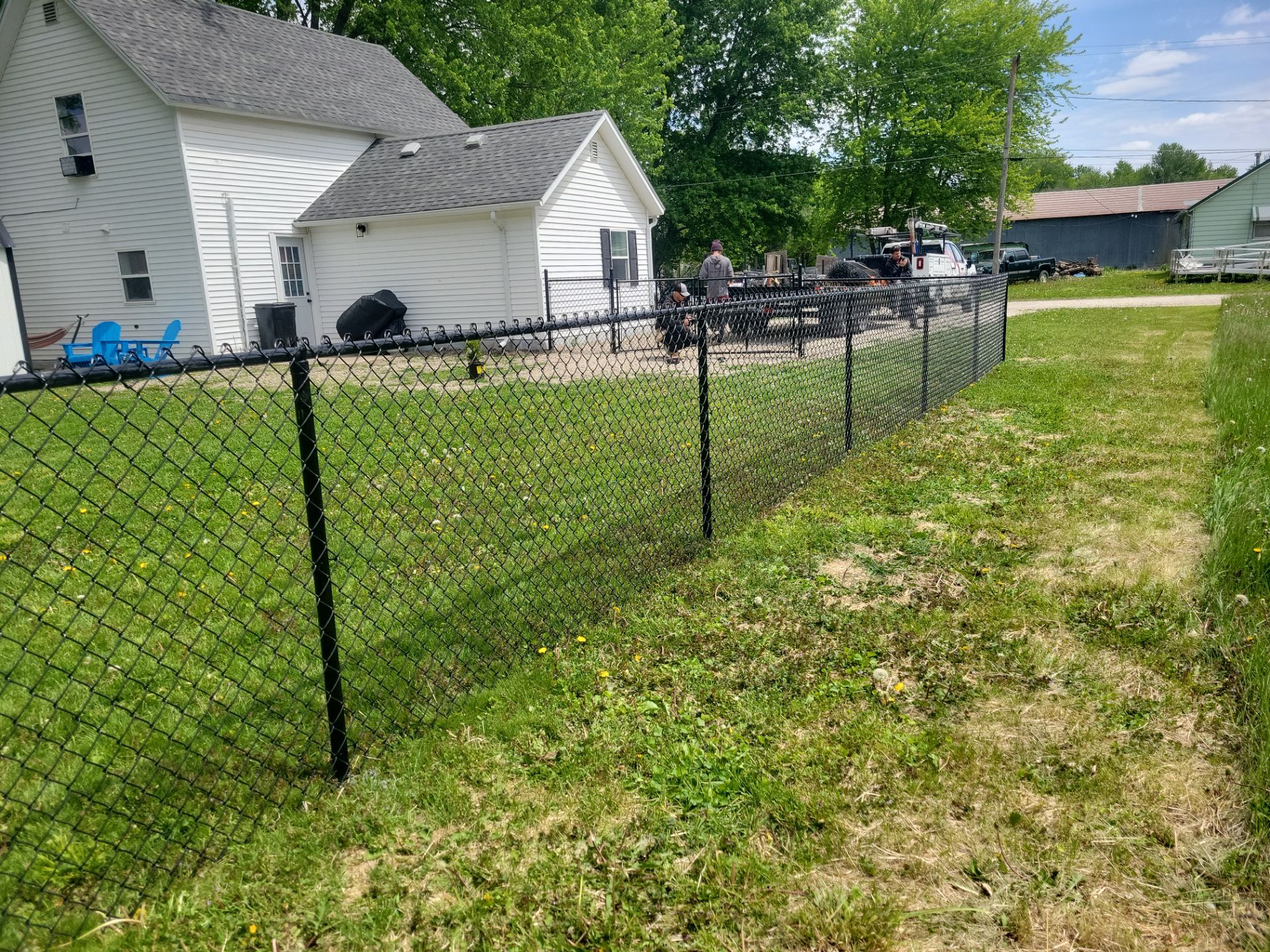 Black Chain Link Fence Installation and Gate in Traer by Perfect Picket Fence and Stain
