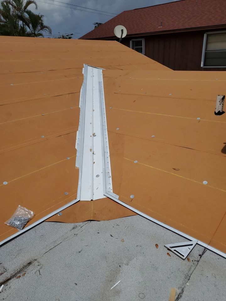 Residential Roofing Installation using 1.5" Nail Strip 24ga Solar White Kynar Coated Standing Seam Metal Panels by Morton Roofing, Inc.