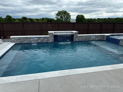 Geometric Pool and Spa with Stone Water Feature Wall