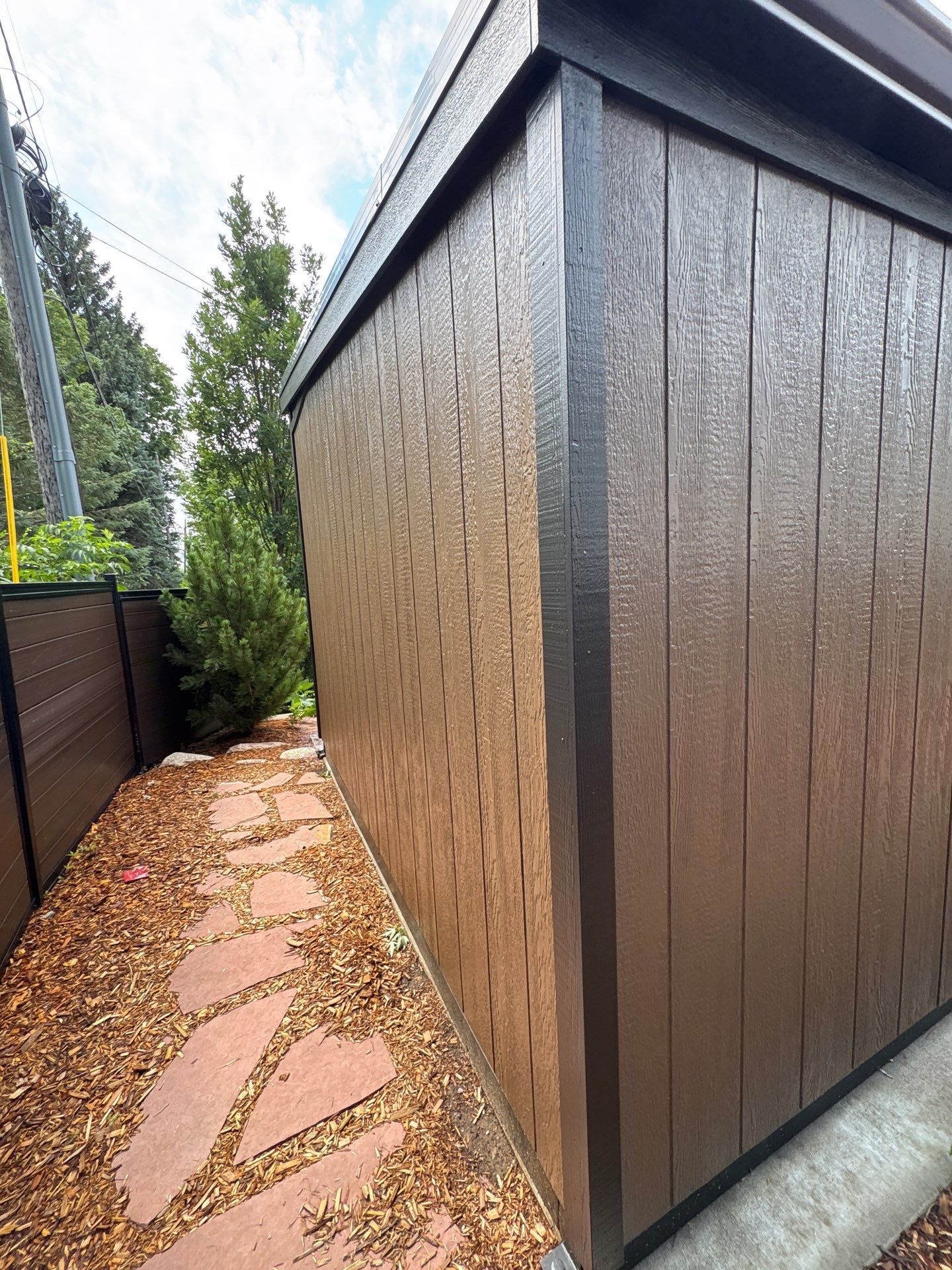 Modern Shed Construction with Stone Foundation in Sioux Falls by Select Painting, Coatings & Garage Cabinets