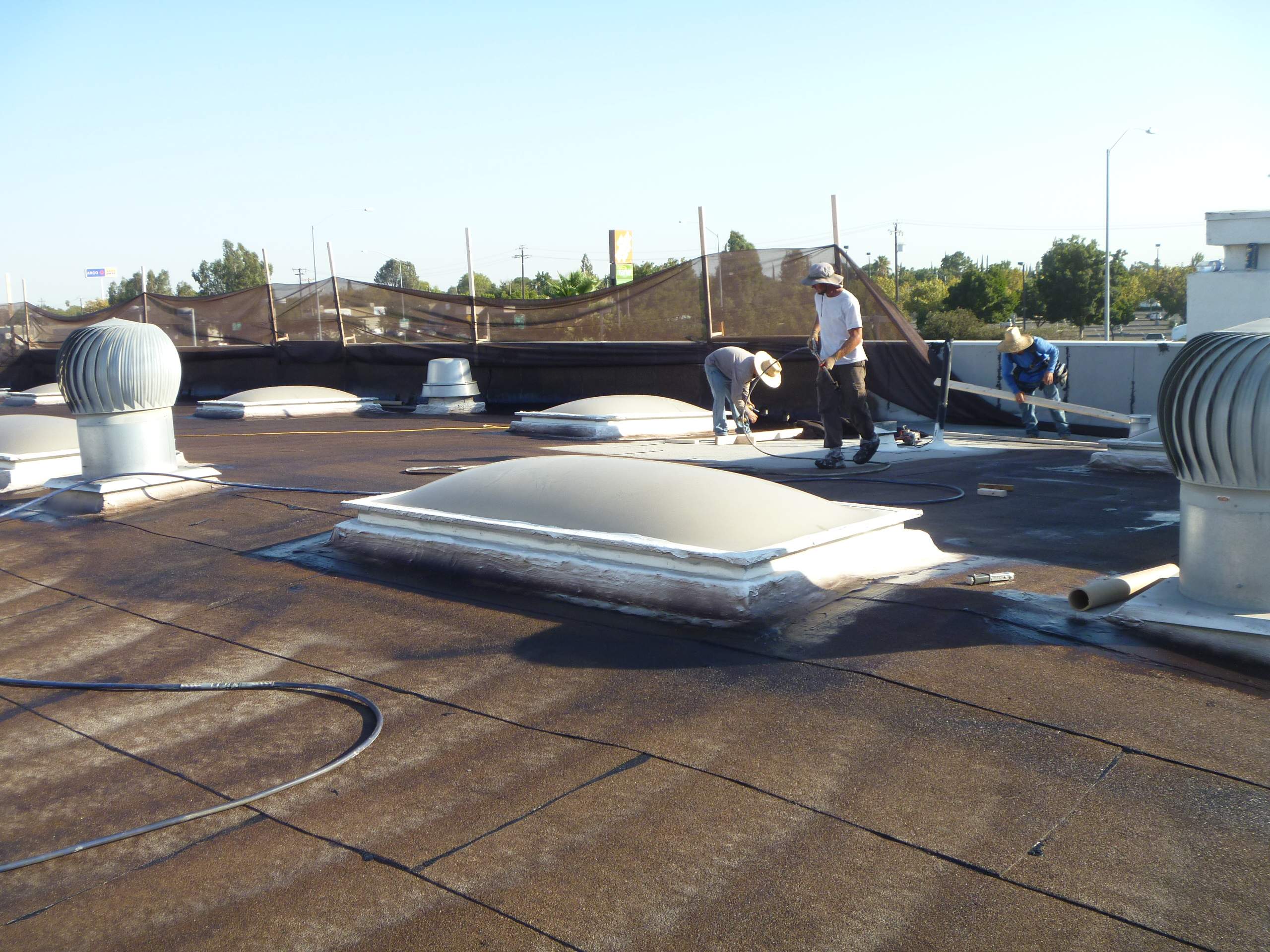 Commercial Roofing Installation using Spray foam and Conklin Benchmark/PUMA XL 18 yr warranty coatings by Straight Edge Roofing Inc