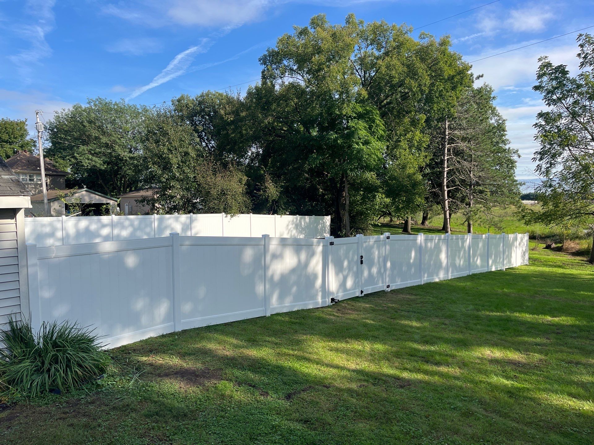 White Vinyl Privacy Fence and Black Chain Link Installation in Sumner by Perfect Picket Fence and Stain