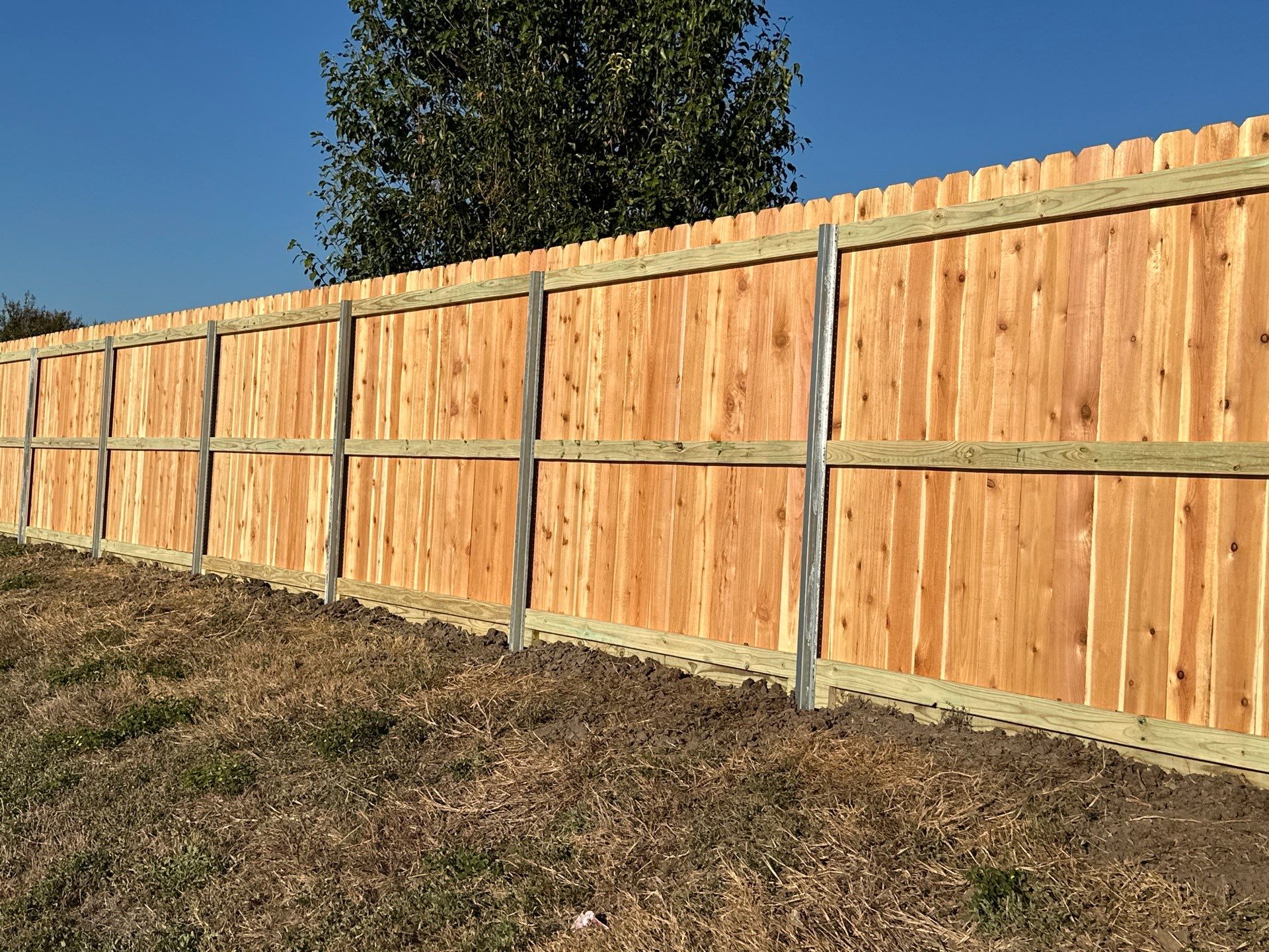 Beautiful Wood fence with metal posts by Tim's Fences