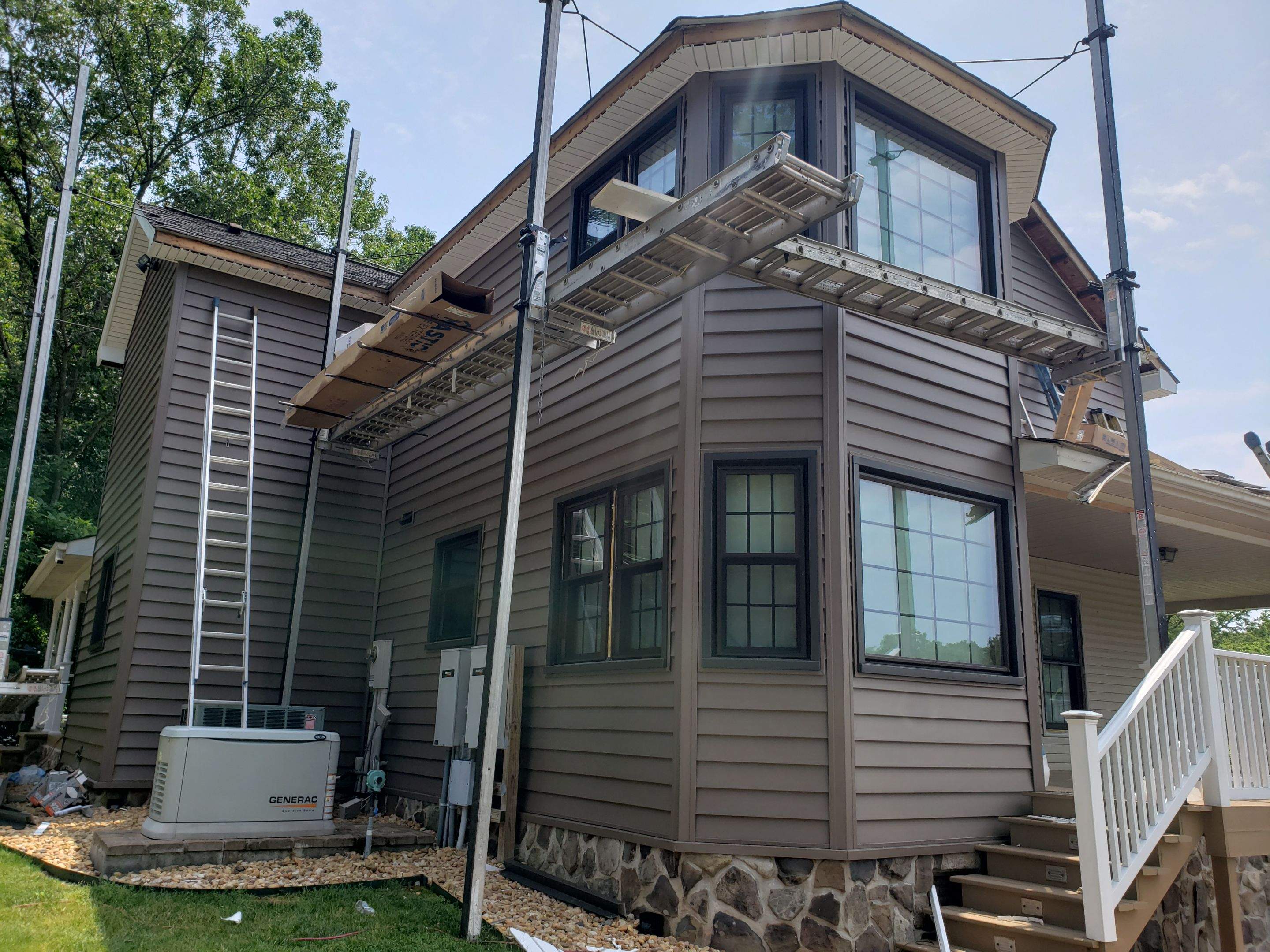Exterior remodel including window replacement by American Home Contractors