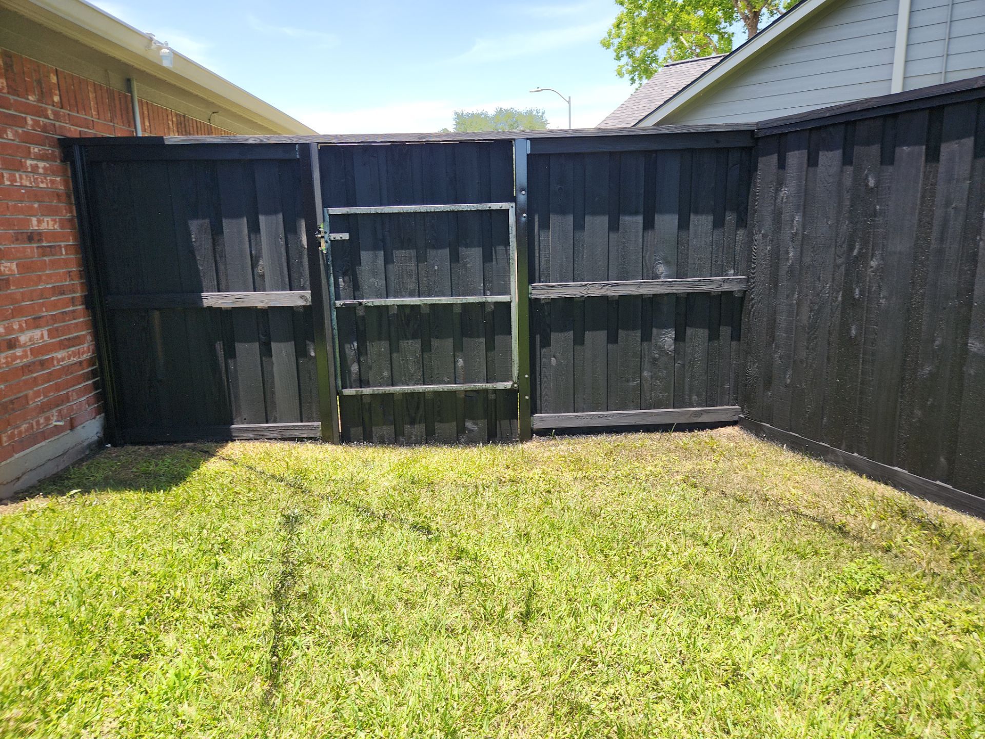 Modern Black Fence Finish by Tim's Fences